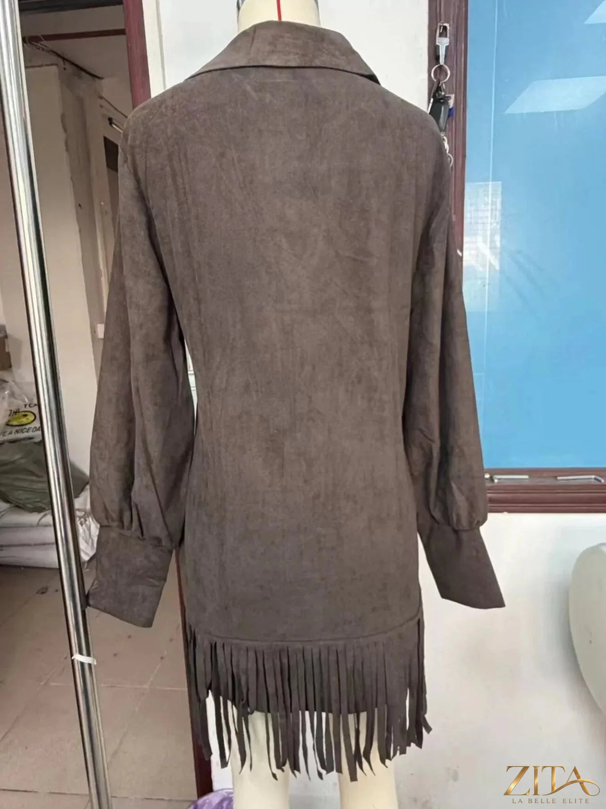 Trendsi fringed lantern sleeve dress with flowing fabric and detailed fringe accents, stylish and perfect for casual or dressy occasions.