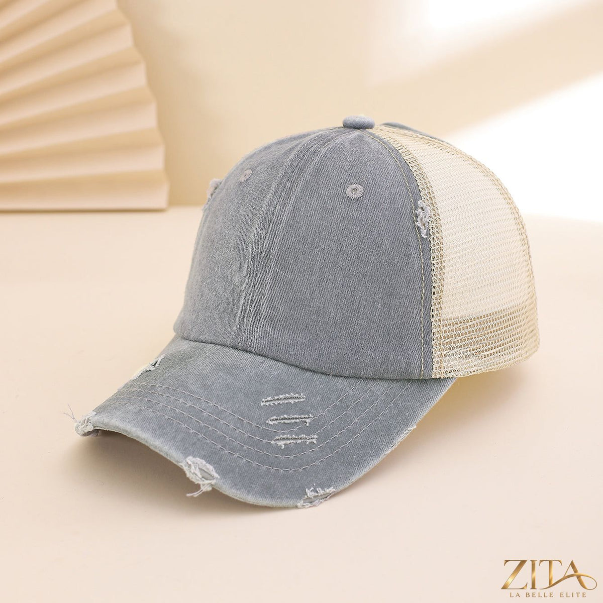 Distressed washed mesh baseball cap by Zita La Belle Elite with a casual, worn-in look and breathable mesh panels.