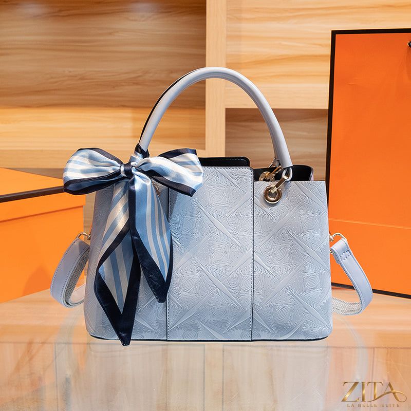 Zita La Belle Elite top-handle handbag in sleek leather with gold hardware and structured design.
