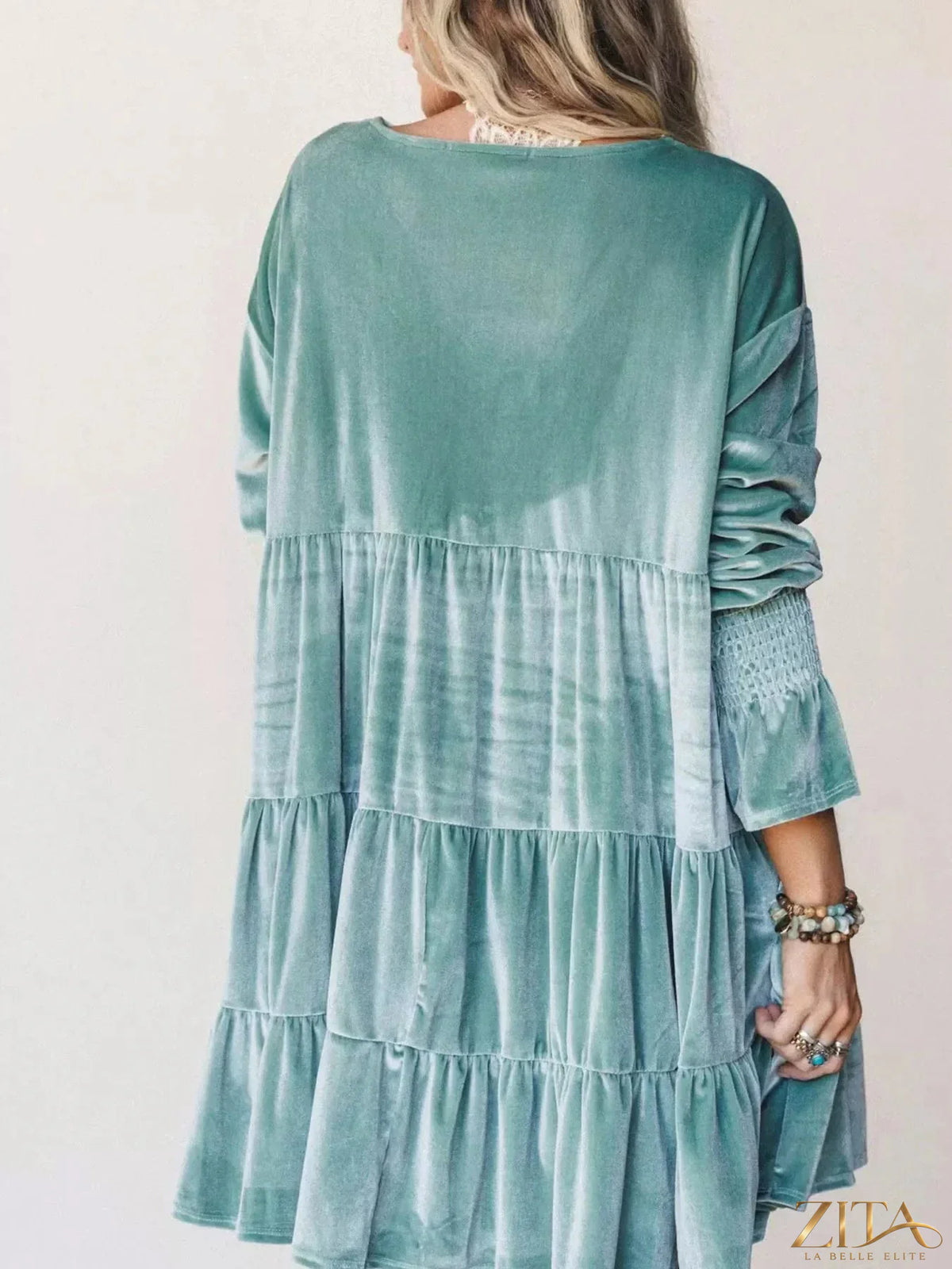 Velvet tiered mini dress with balloon sleeves by Zita La Belle Elite, shown in a stylish indoor setting.