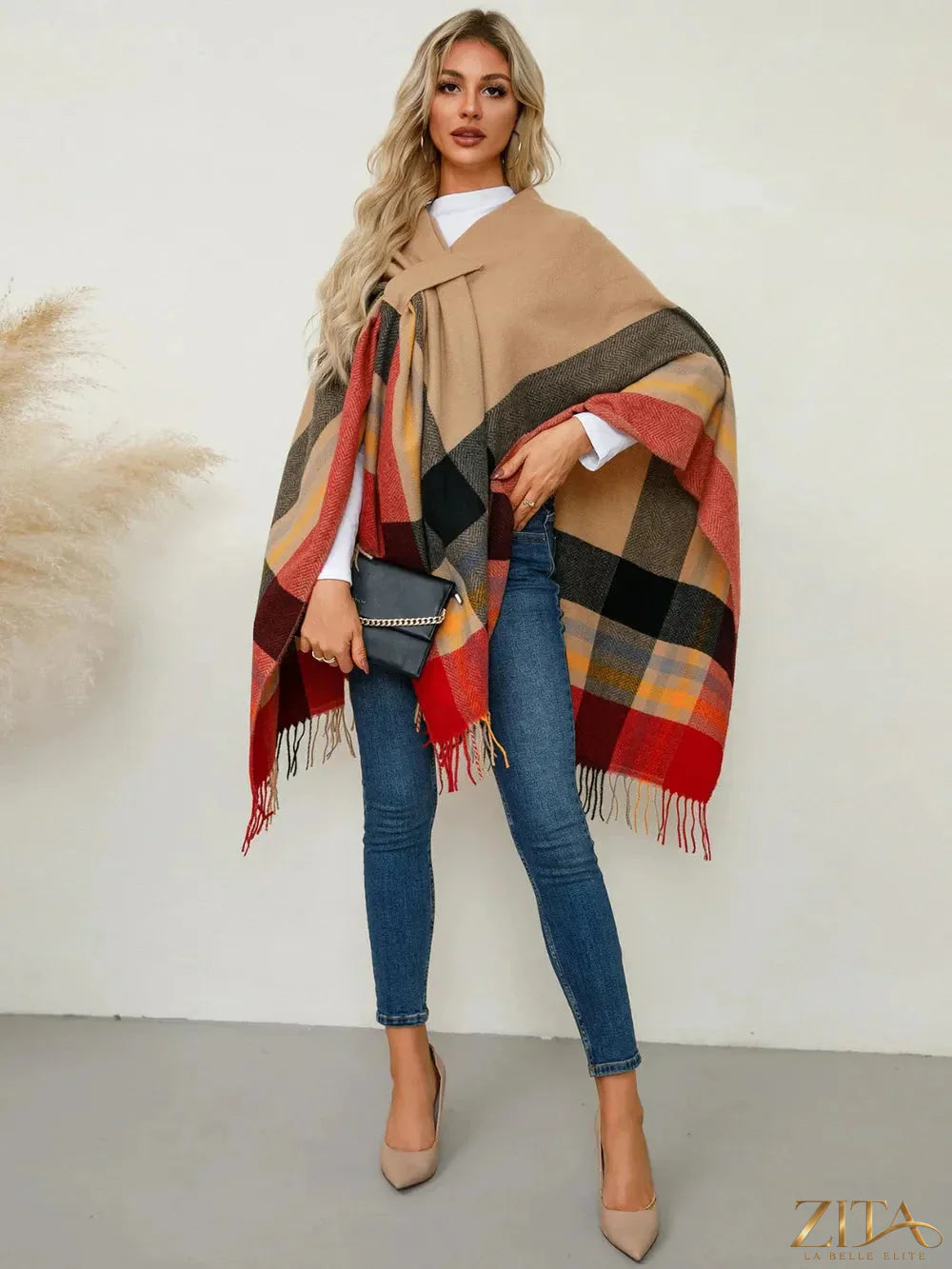 Trendsi fringe contrast plaid poncho with fringed edges, featuring a stylish red, black, and white plaid pattern on soft fabric.