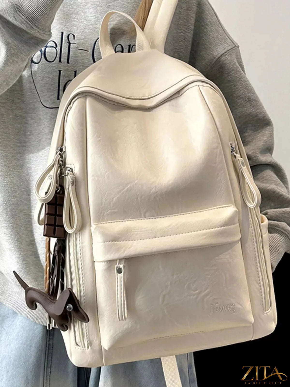Leather texture backpack bag with adjustable straps and multiple compartments, featuring a sleek, stylish design from Trendsi.