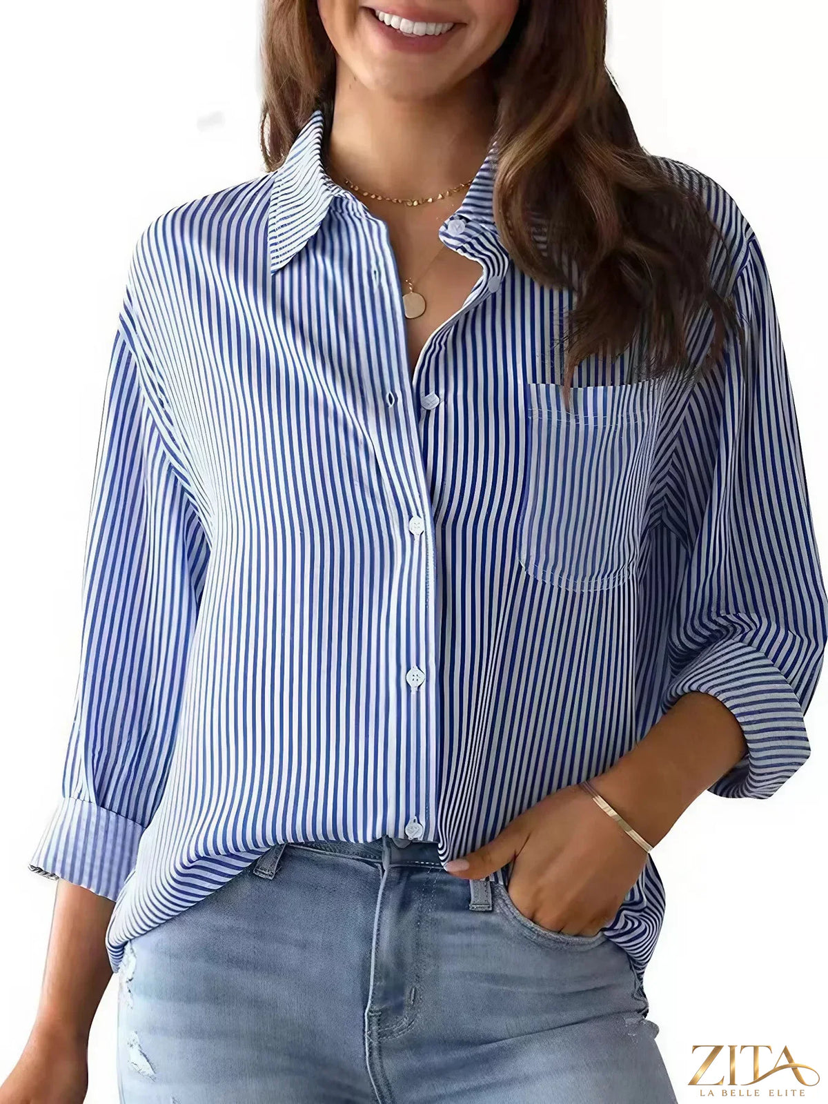 Zita La Belle Elite classic striped button-down shirt in blue and white, shown on a hanger with collar and long sleeves.