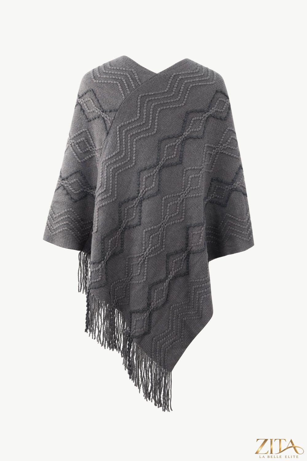 Pearl trim V-neck fringe hem poncho from Trendsi, featuring elegant pearl details and flowing fringe at the hem.