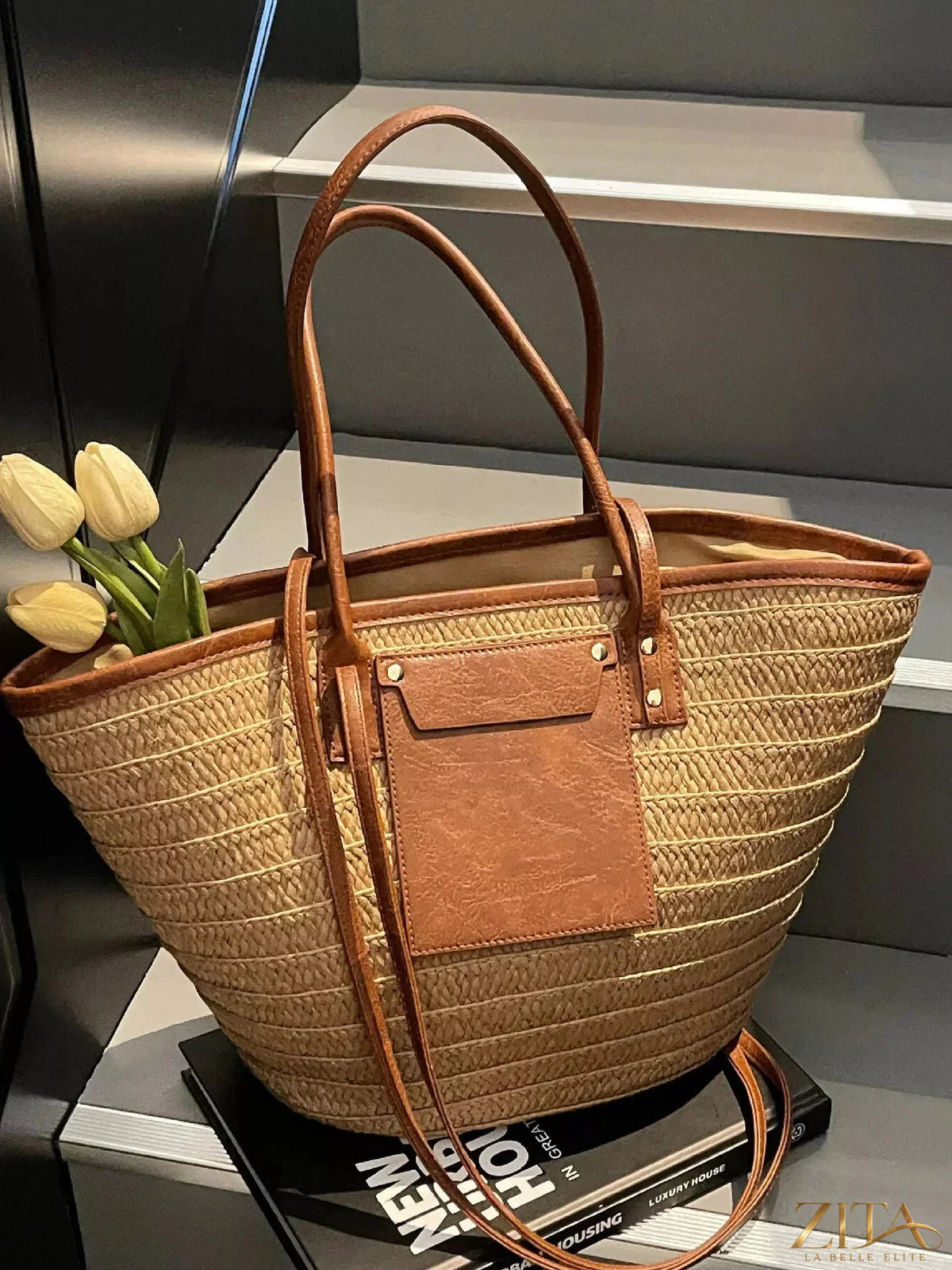 Woven straw tote bag by Zita La Belle Elite with leather handles and spacious interior, perfect for casual shopping or beach outings.