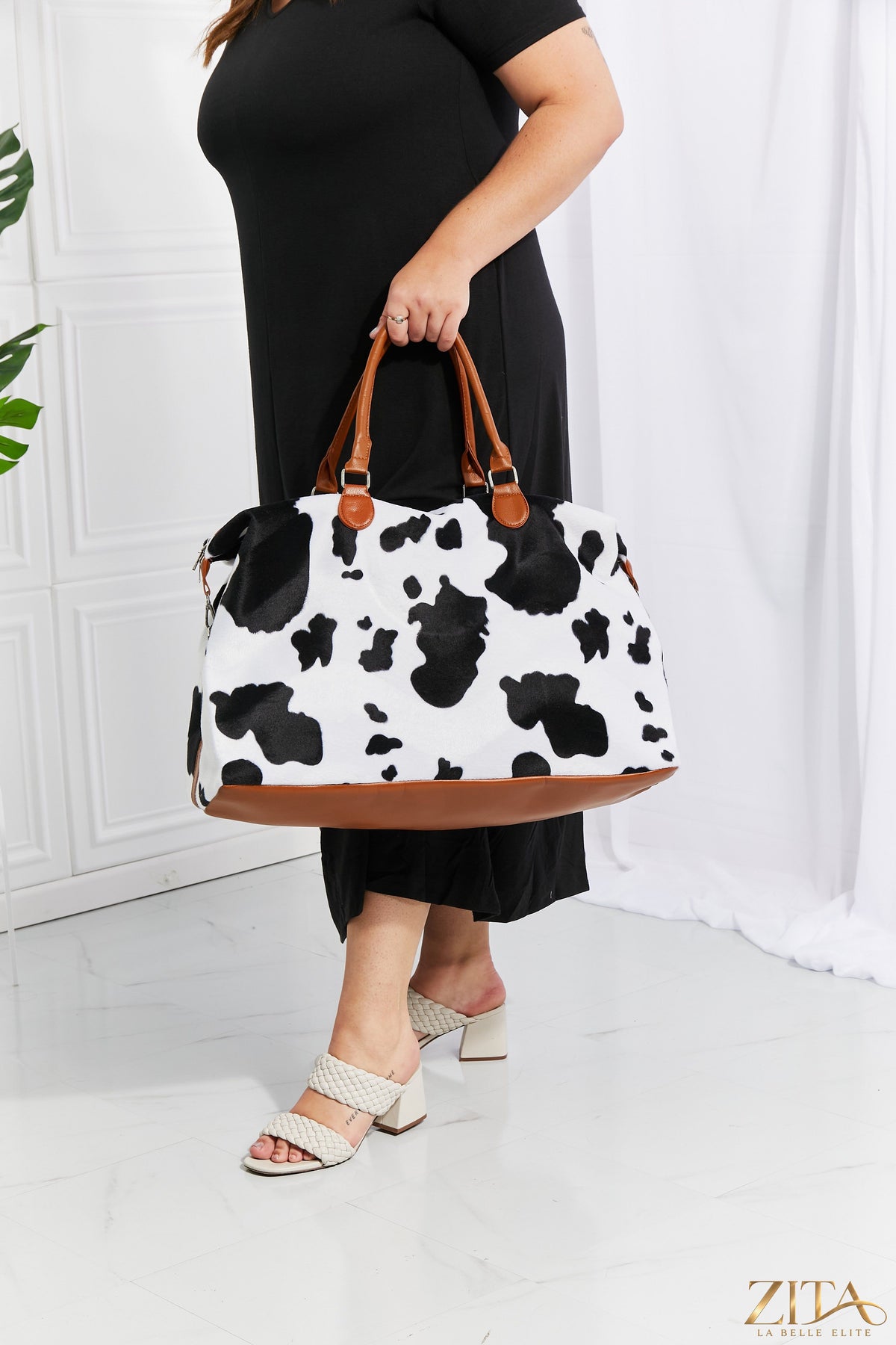 Zita La Belle Elite animal print plush weekender bag with zebra pattern and sturdy handles, perfect for travel and weekend trips.