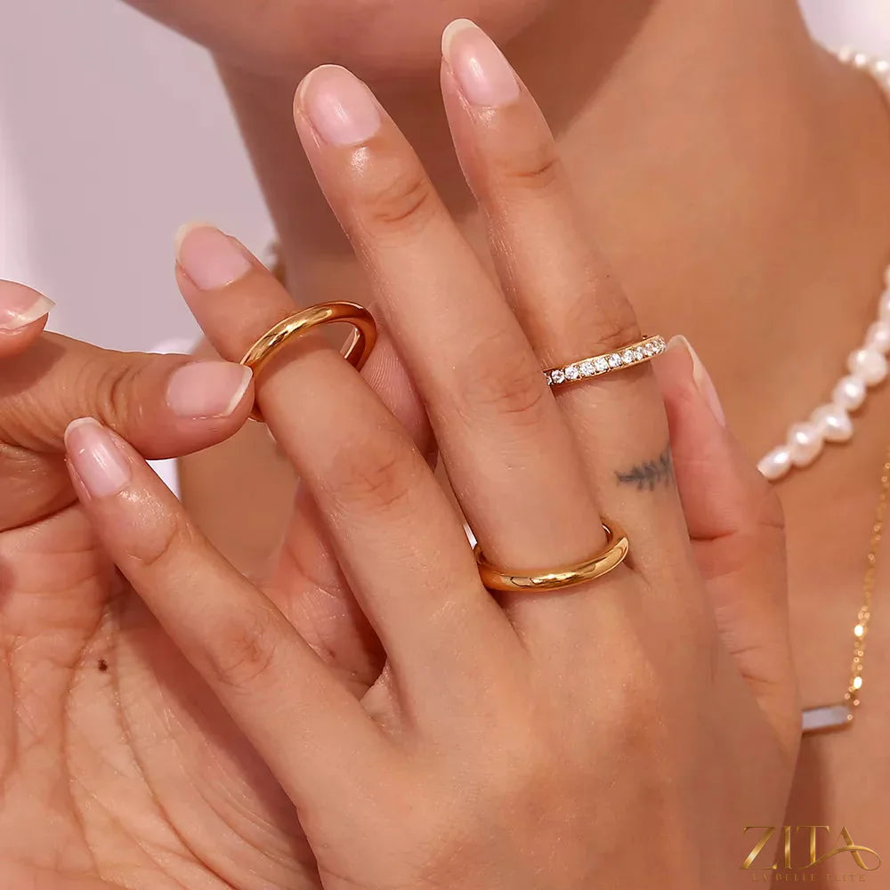 Three stainless steel zircon rings from Zita La Belle Elite, showcasing shiny finishes and intricate designs in a set.