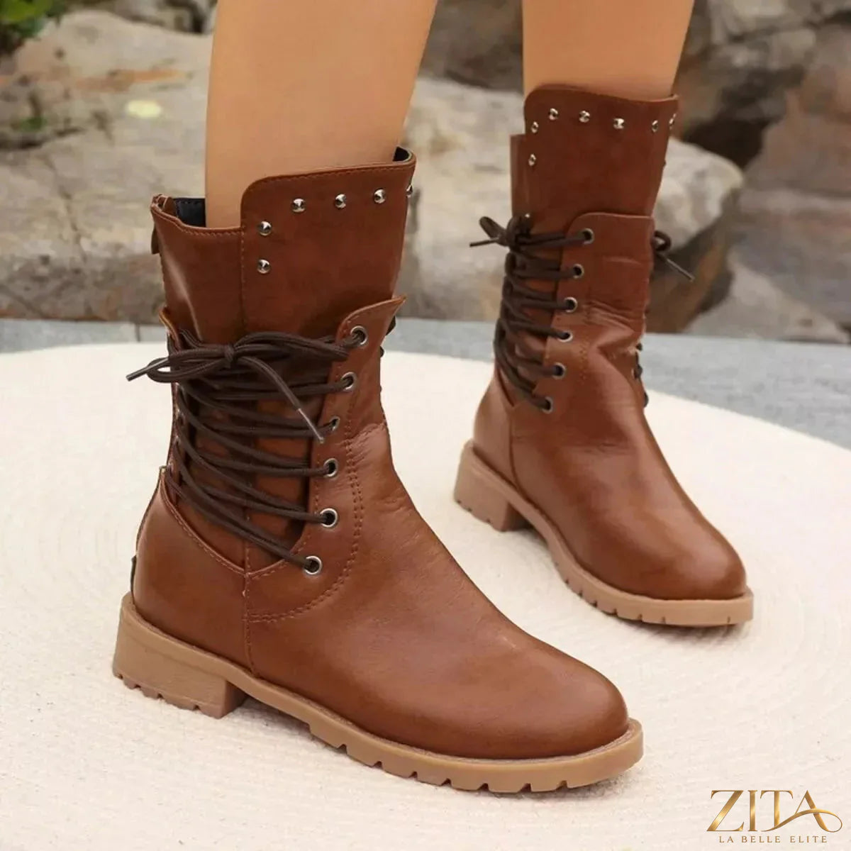 Black studded lace-up boots from Trendsi featuring metal studs, chunky heels, and durable leather material.