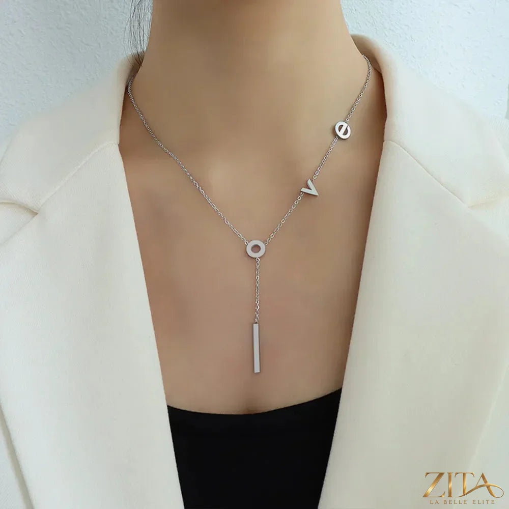 Titanium steel letter necklace from Zita La Belle Elite featuring a sleek, modern design with a pendant hanging on a silver chain.