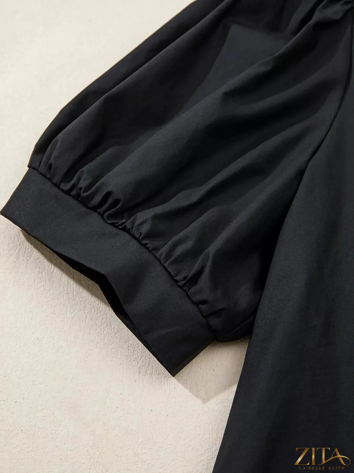 Zita La Belle Elite notched puff sleeve blouse with feminine ruffled details and lightweight fabric, stylishly displayed on a hanger.