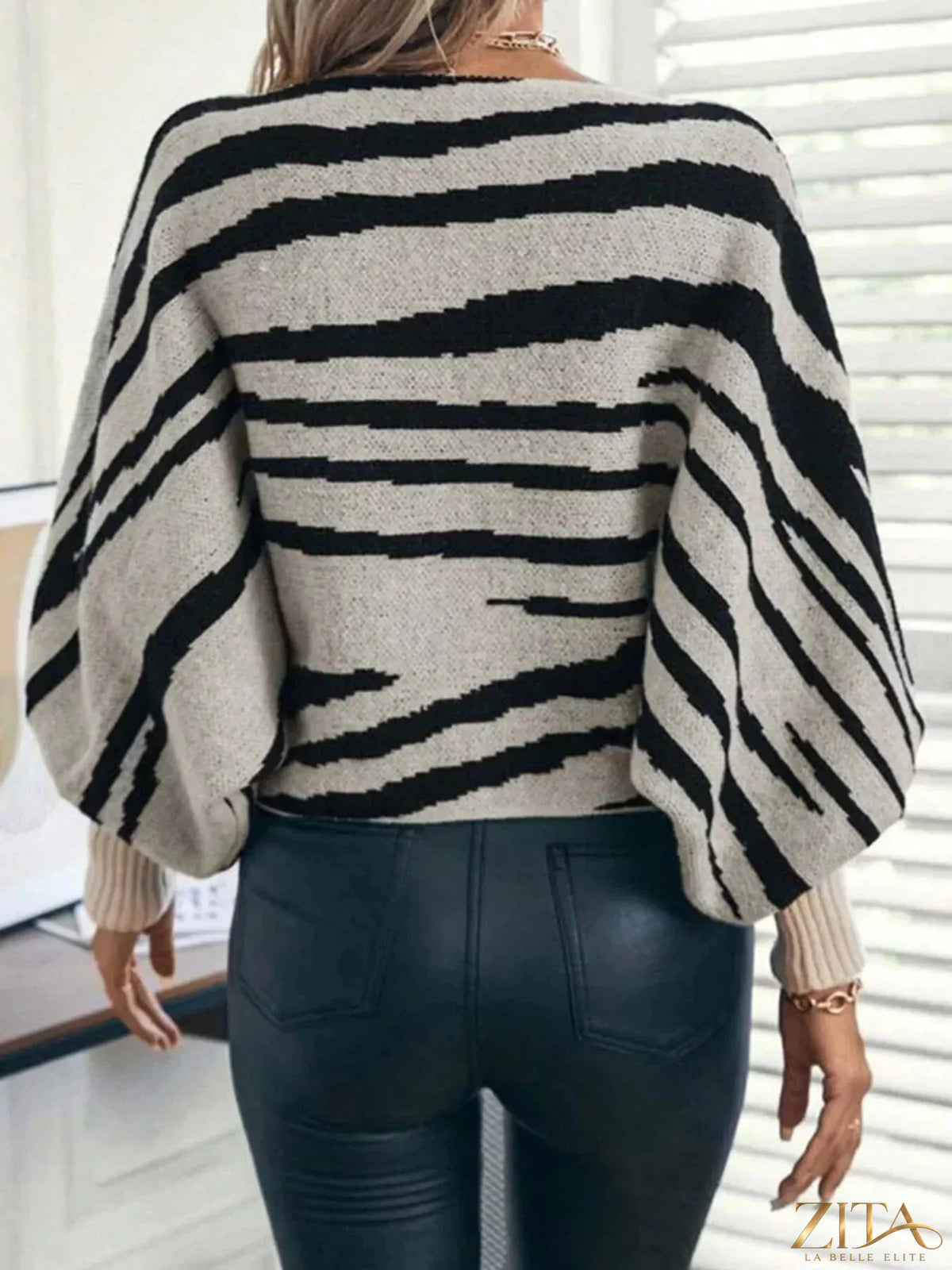 Striped lantern sleeve sweater by Trendsi featuring a cozy knit with bold stripe patterns and relaxed fit.