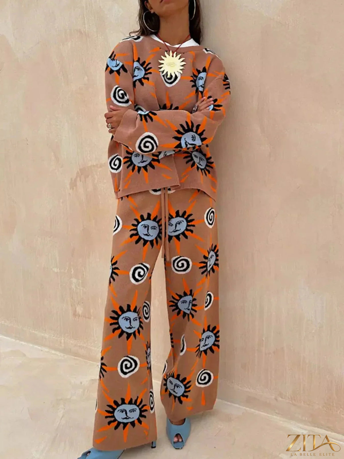 Zita La Belle Elite sun graphic top, matching cardigan, and pants 3-piece sweater set displayed on a hanger.