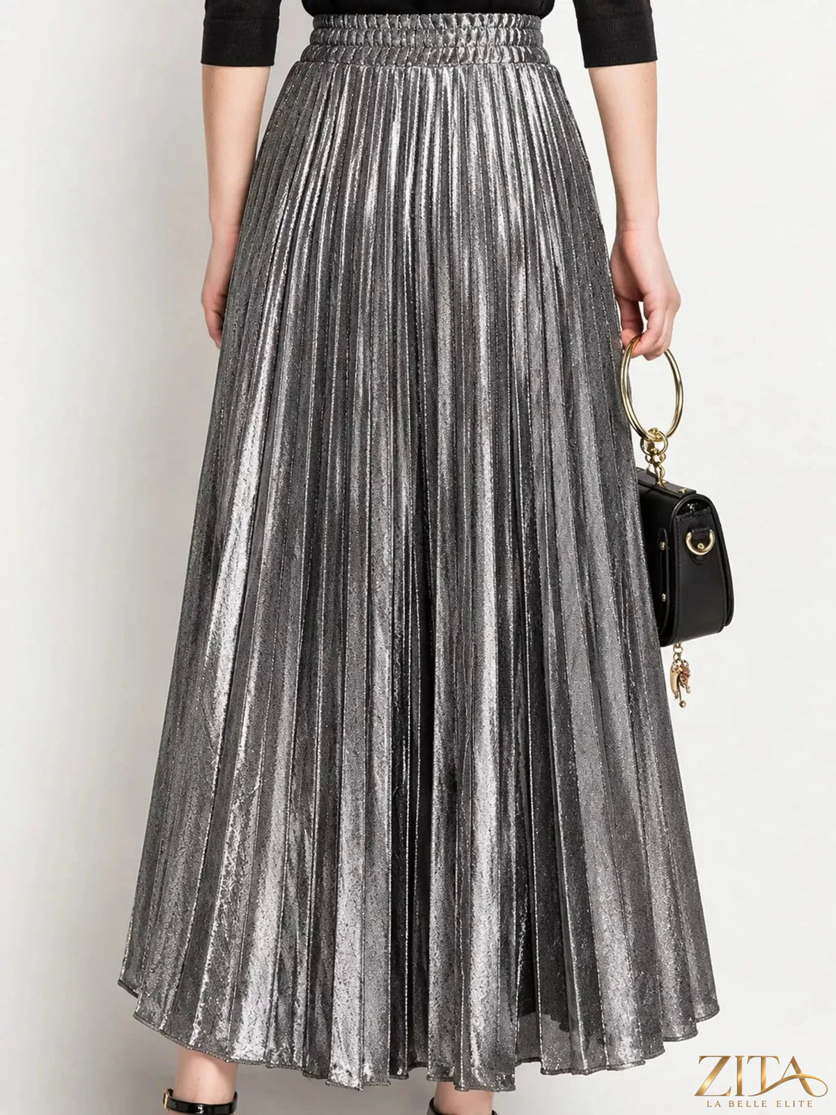High-waisted pleated maxi skirt in flowing fabric, stylish design by Trendsi, shown in a full-length view.