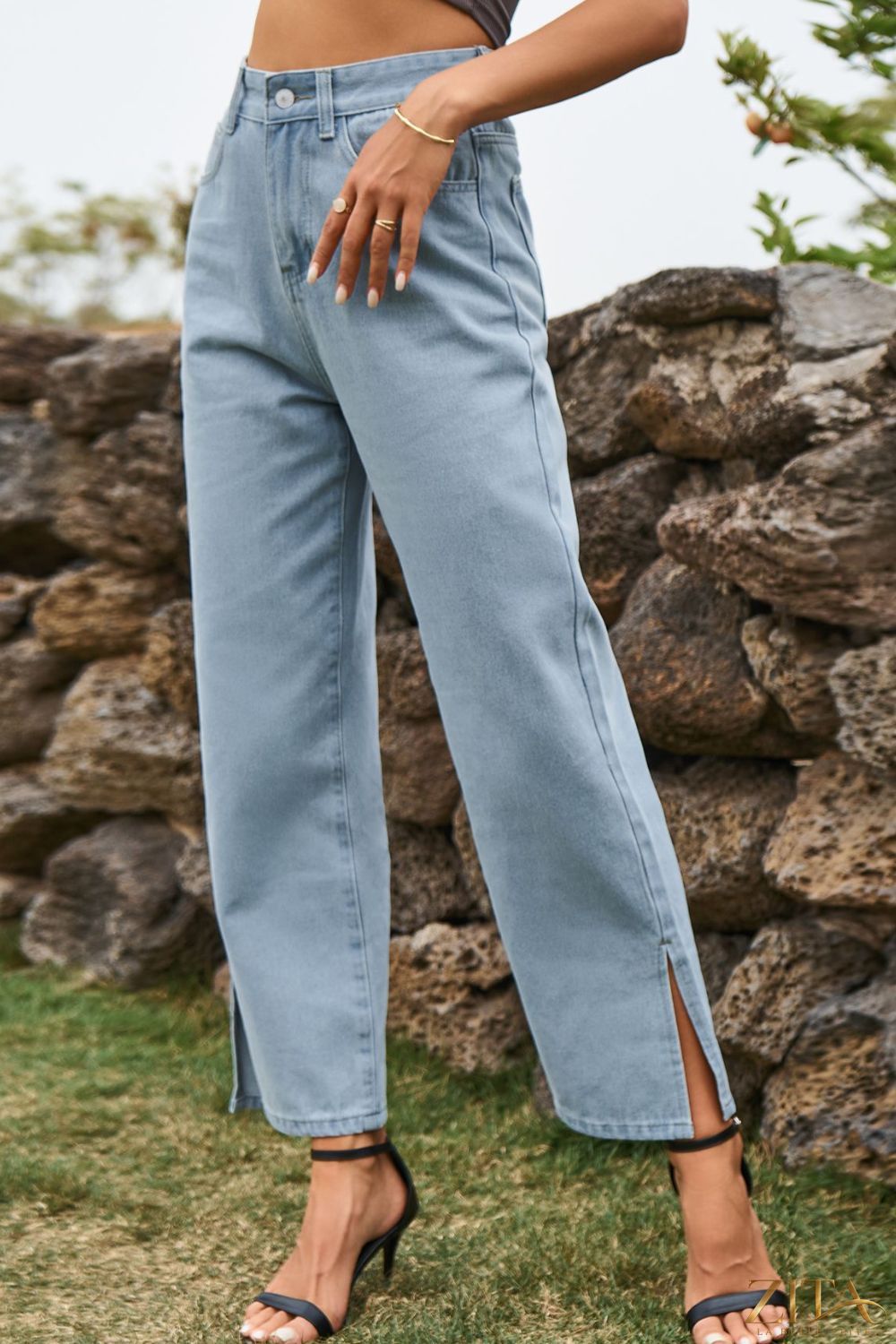 Light blue high waist loose fit ankle slit jeans by Zita La Belle Elite, showing the relaxed fit and stylish slit detail at the ankles.