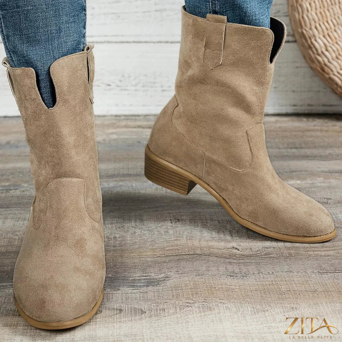 Brown suede block heel Western boots with pointed toes and decorative stitching, styled on a mannequin.