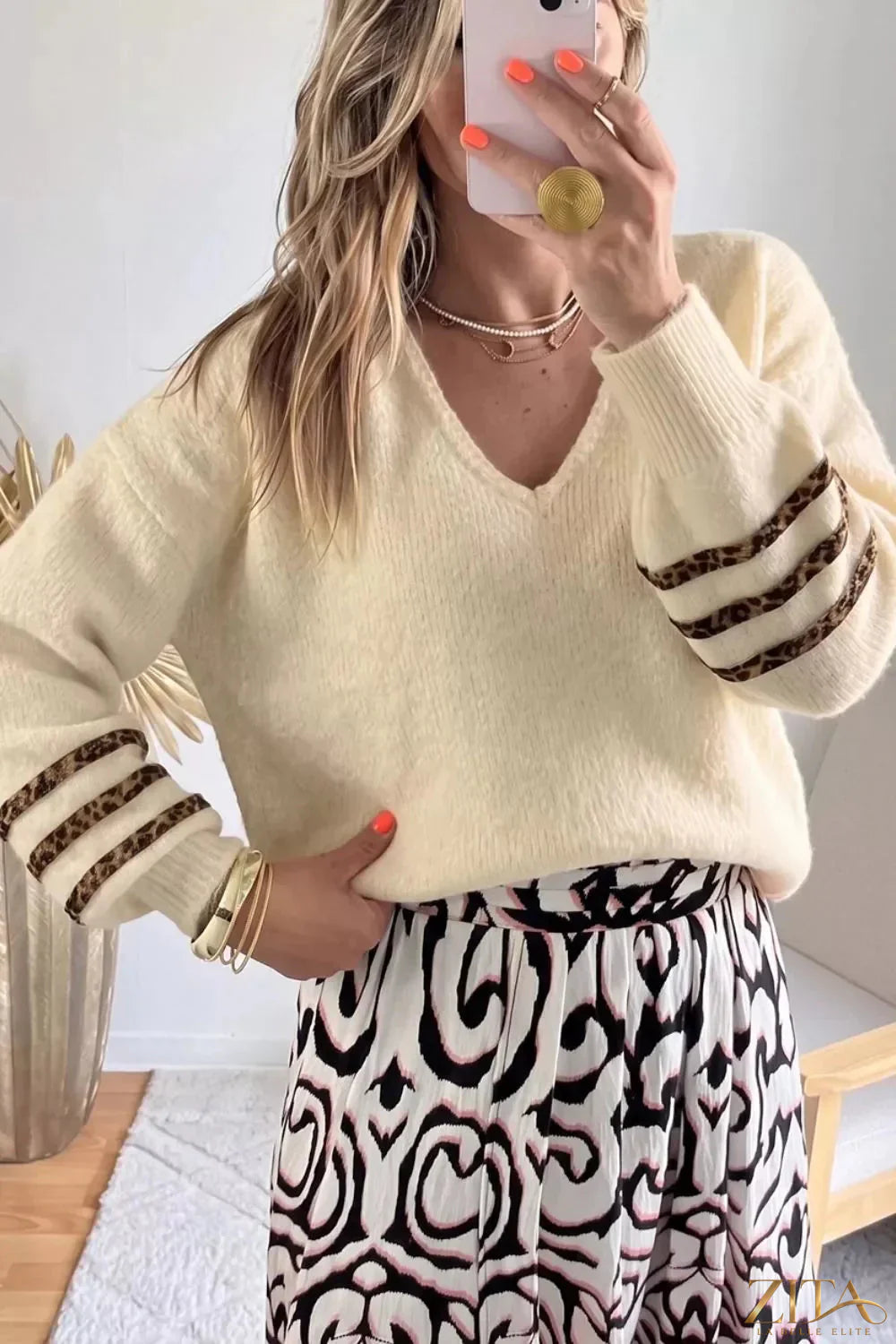 Leopard striped V-neck sweater by Zita La Belle Elite, featuring a cozy knit with animal print and contrasting pattern.