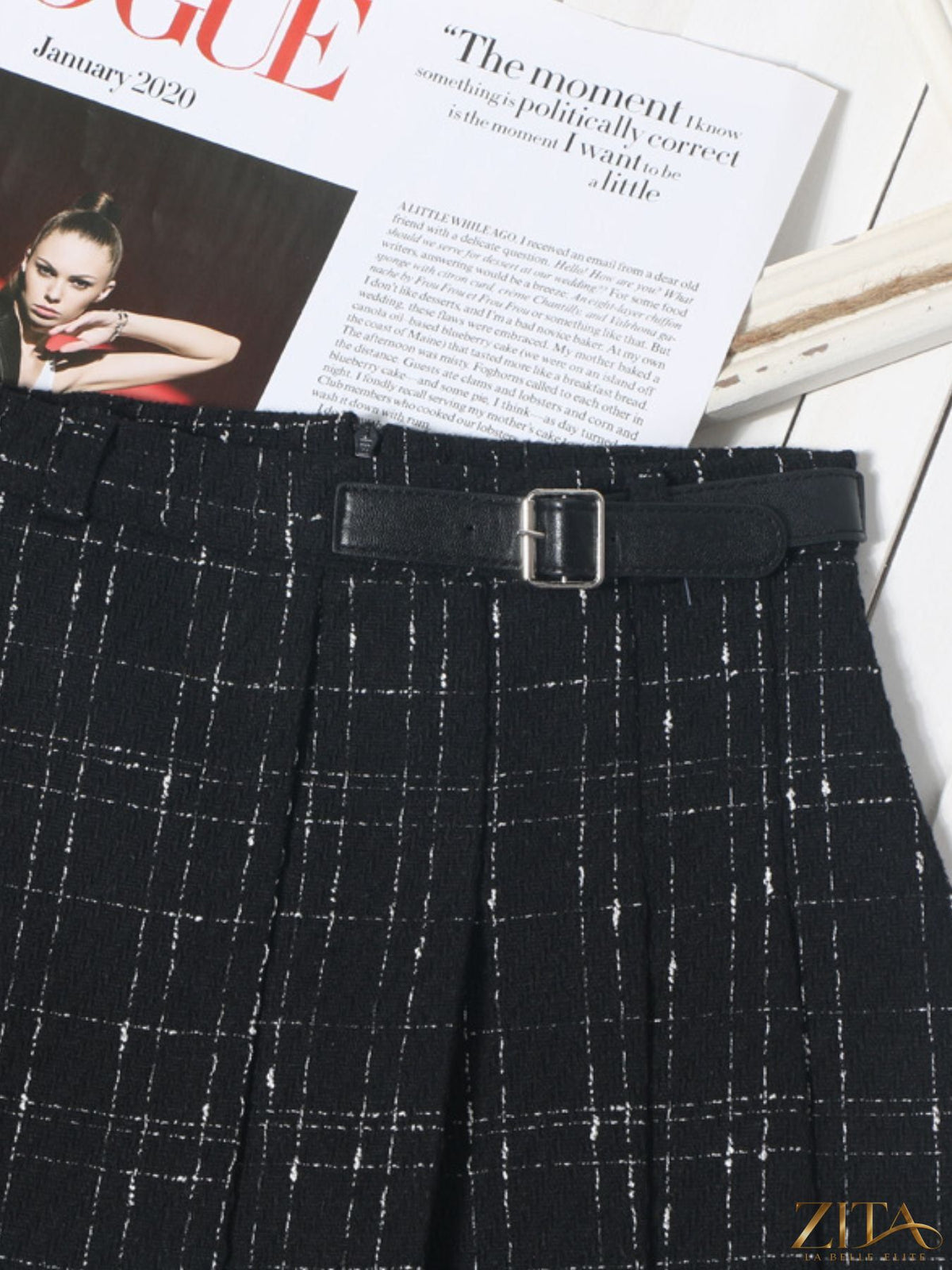 Zita La Belle Elite pleated plaid mini skirt shown on a model, featuring a high waist and classic checkered pattern.