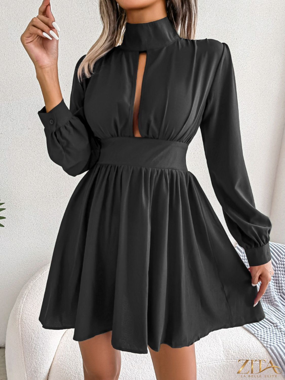 Black cutout turtleneck A-line mini dress by Trendsi featuring a fitted silhouette and stylish neckline, shown on a model.
