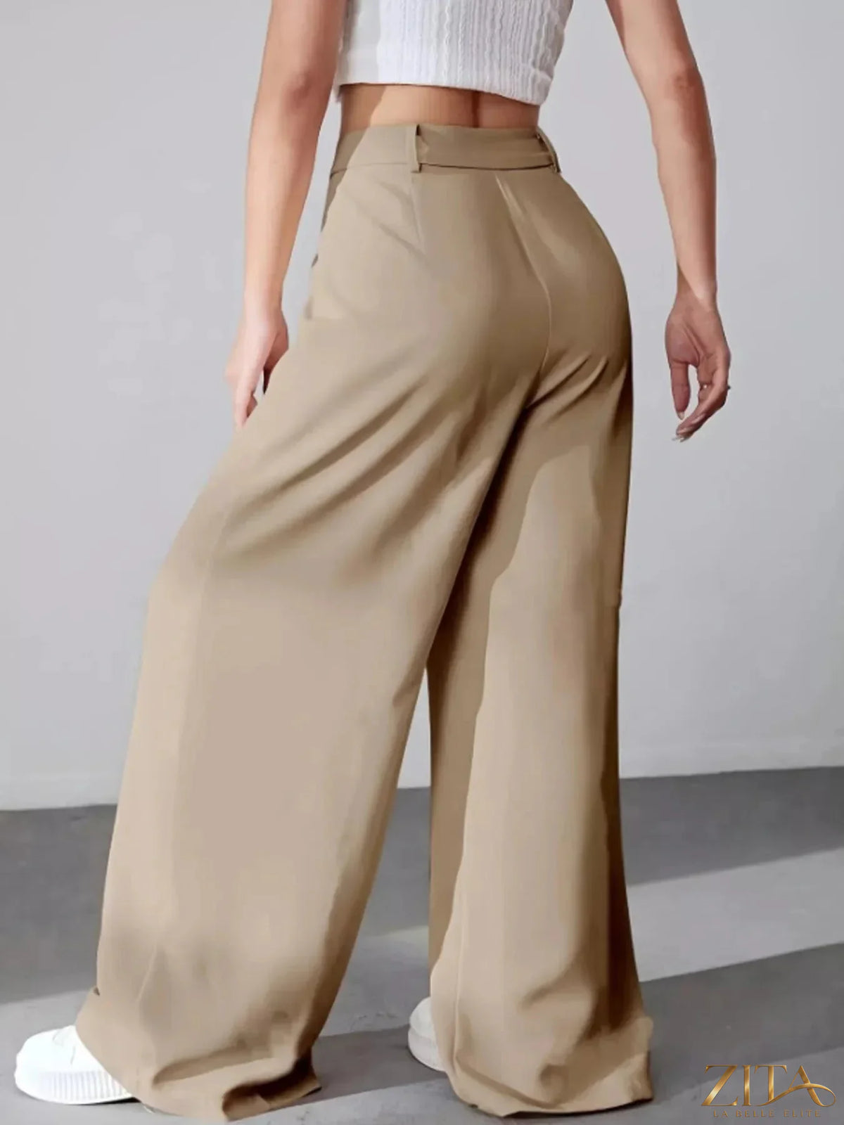 Zita La Belle Elite wide leg pleated pants in neutral fabric, featuring a high waist and flowing silhouette.