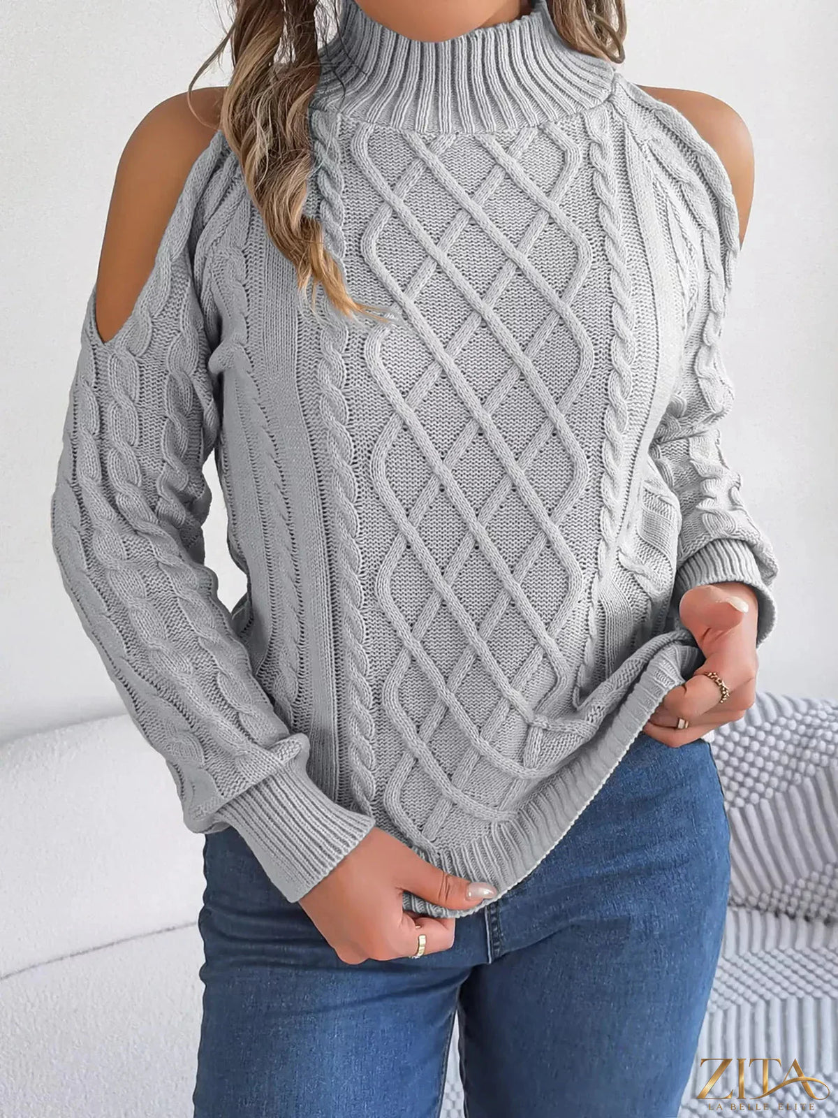 Zita La Belle Elite cold-shoulder cable knit sweater in cozy, textured fabric with cut-out shoulders and long sleeves.