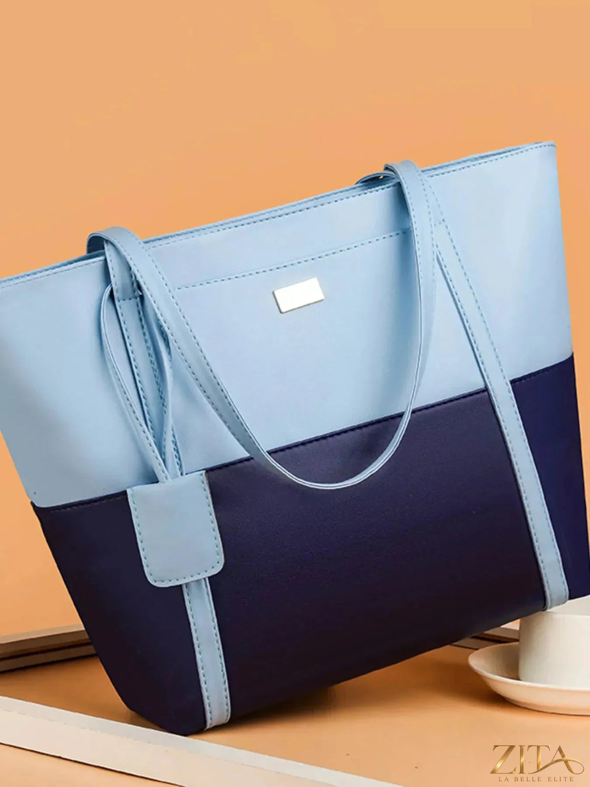 Two-tone tote bag by Zita La Belle Elite featuring a stylish design with dual color panels and sturdy handles.
