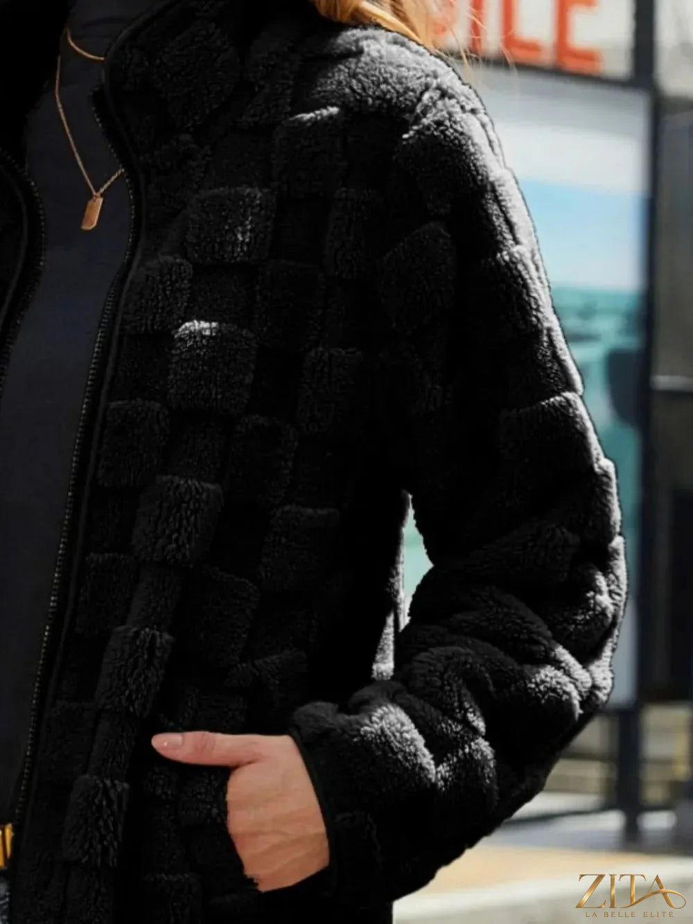 Fuzzy checkered zip-up jacket by Zita La Belle Elite featuring a cozy, stylish design with a black and white checkered pattern.