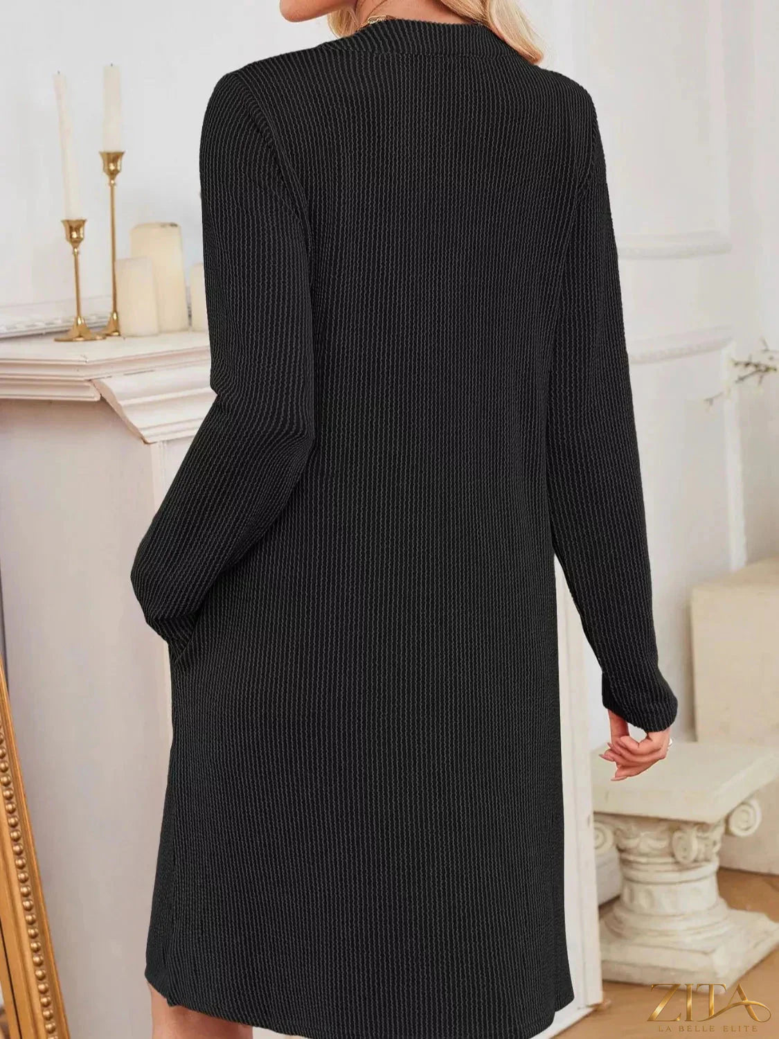 Zita La Belle Elite casual ribbed knit long sleeve dress hanging on a wooden hanger, showcasing its fitted silhouette and textured fabric.
