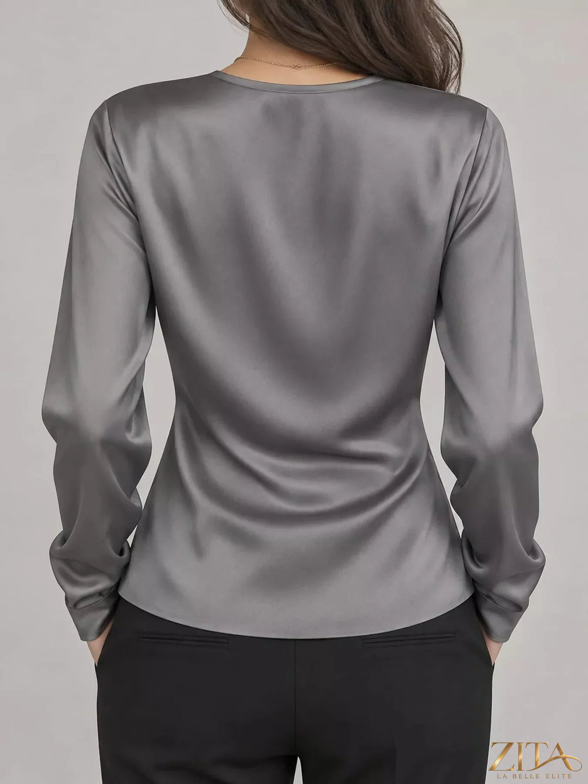 Zita La Belle Elite satin surplice long sleeve blouse with elegant draping and a V-neck, displayed on a neutral background.