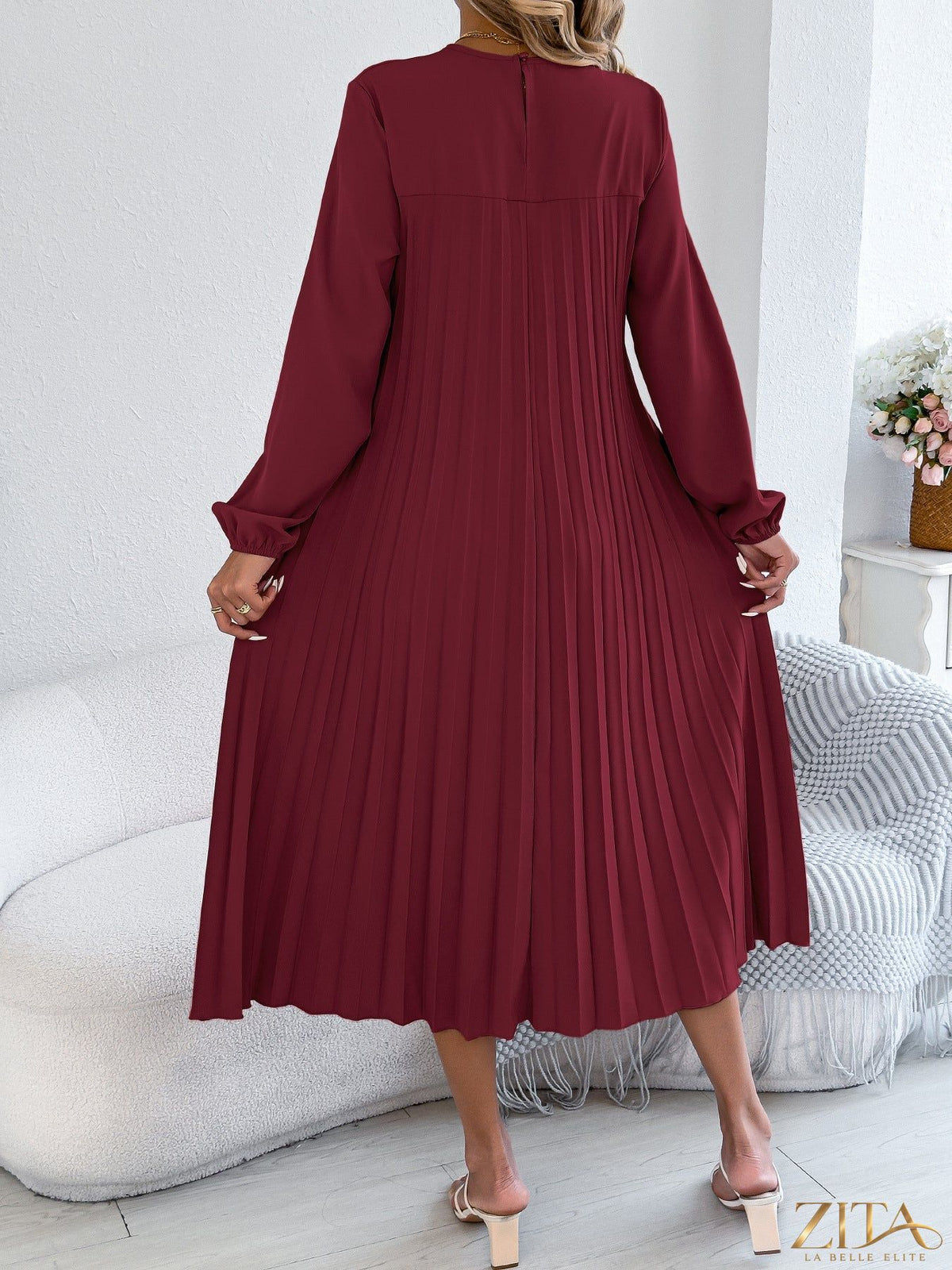 Zita La Belle Elite pleated A-line midi dress with a fitted bodice and flowing skirt, shown on a model.