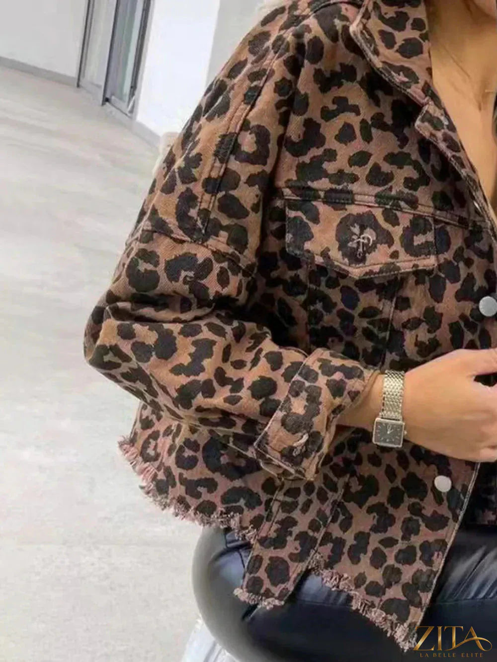 Raw hem leopard-collared denim jacket by Trendsi with leopard print collar and distressed raw hem, styled on a model.