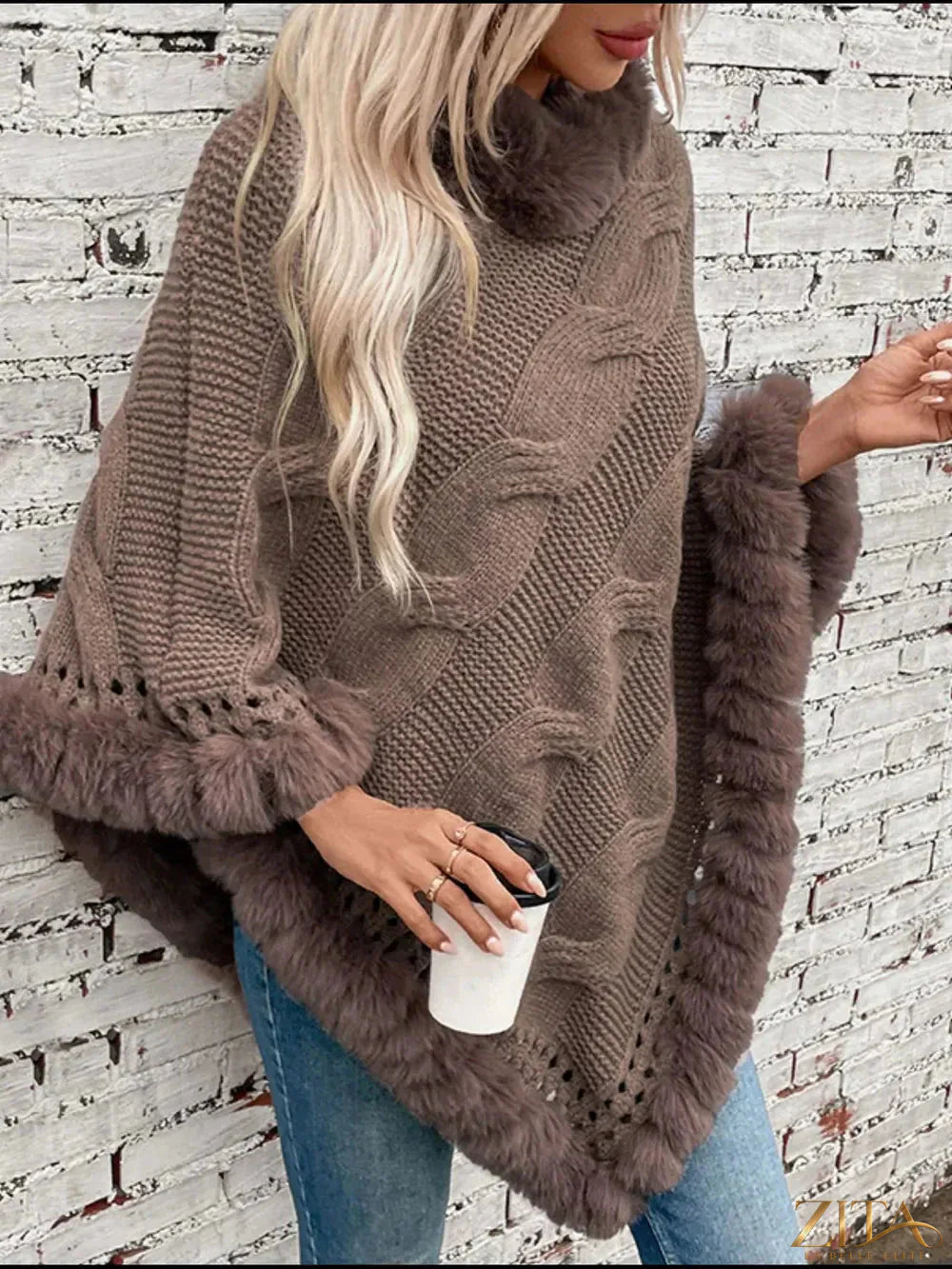 Fuzzy hem cable-knit poncho from Trendsi featuring a cozy, textured knit with a relaxed fit and stylish design.