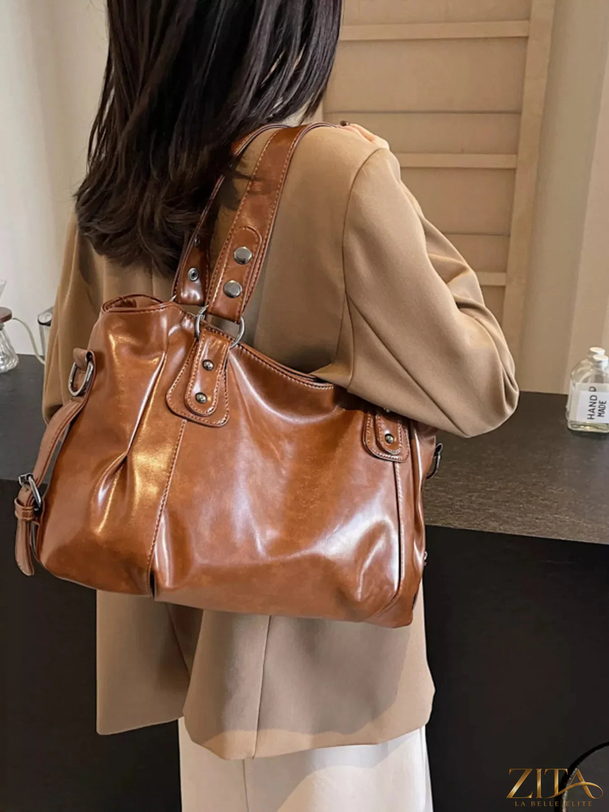 Vintage style leather handbag by Trendsi featuring a classic design with sturdy handles and aged leather finish.