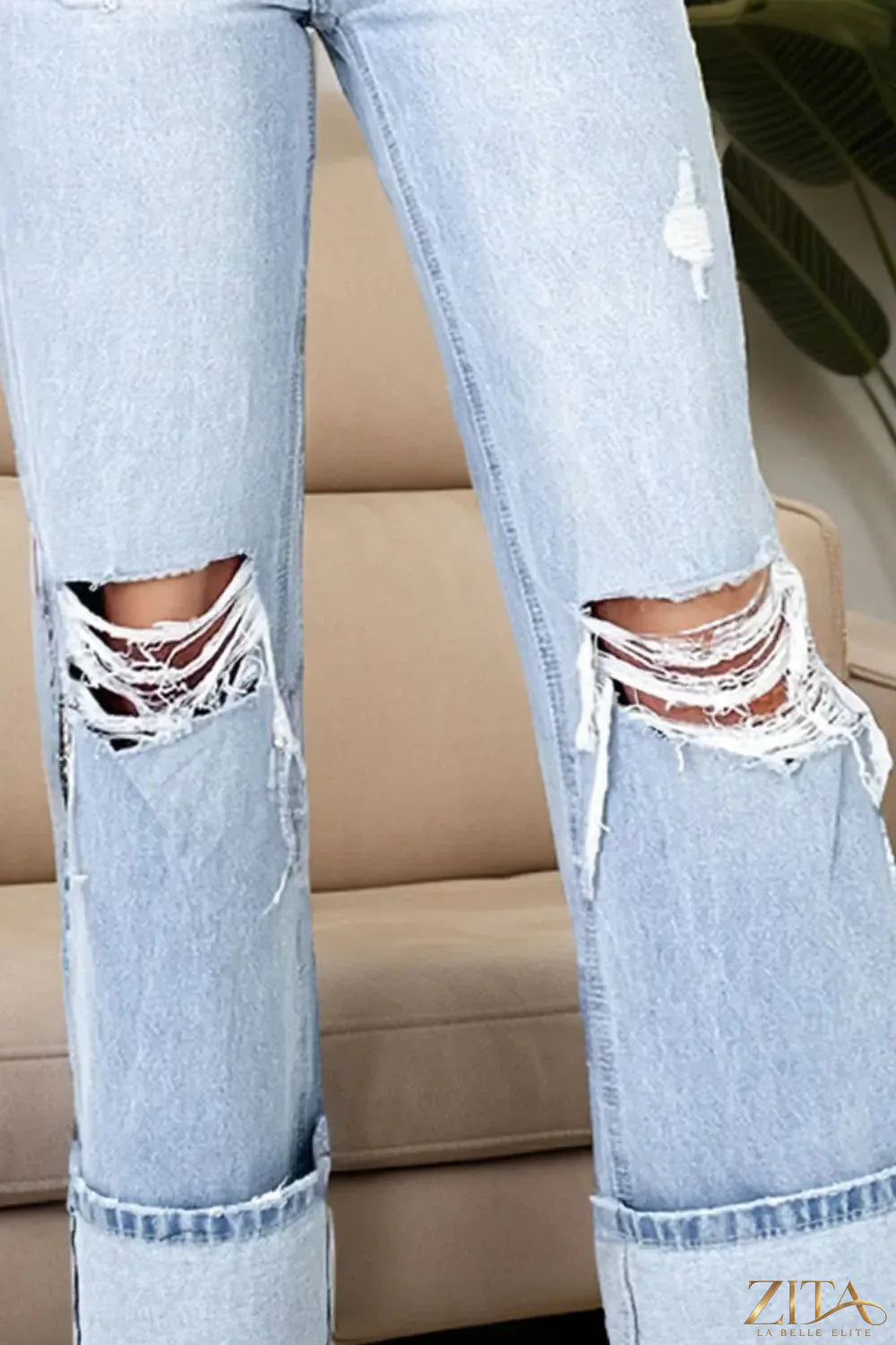 Distressed high waist jeans with pockets by Zita La Belle Elite, showcasing a trendy, worn-in denim look and functional front and back pockets.