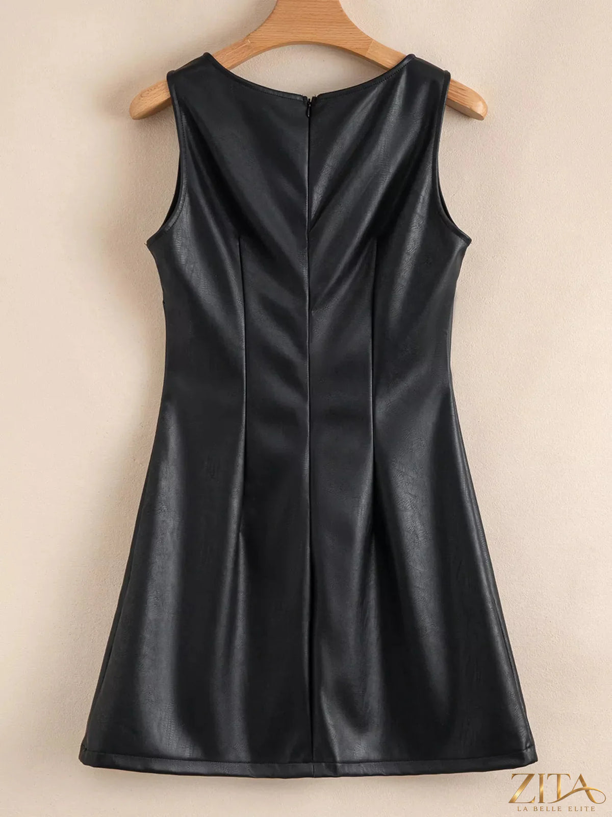 Vegan leather sleeveless mini dress by Zita La Belle Elite, close-up showing black minimalistic design and smooth fabric.