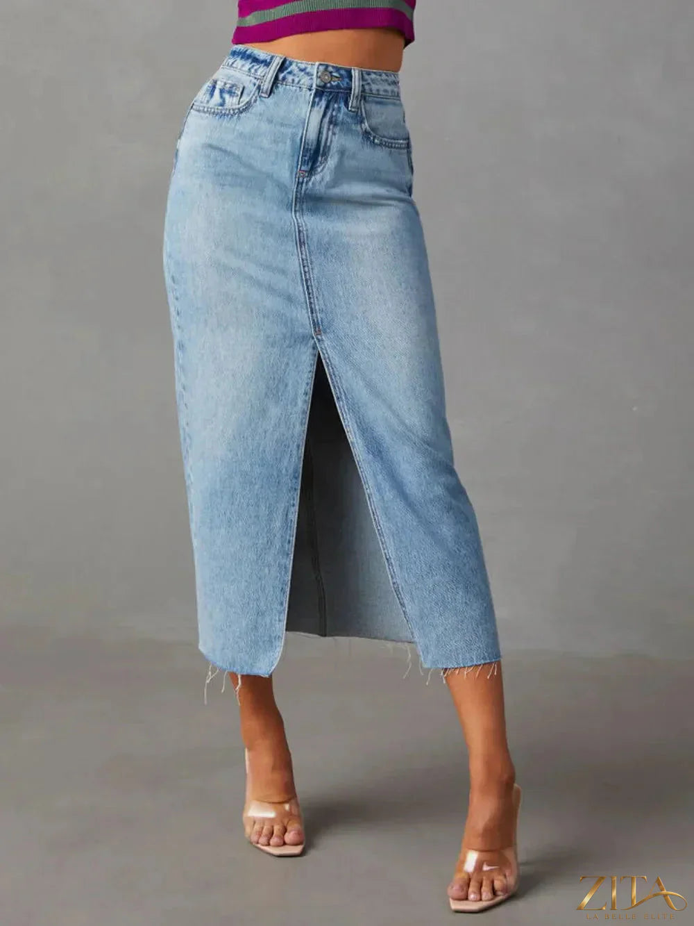 Raw hem front slit denim midi skirt by Zita La Belle Elite, featuring a stylish slit and distressed hem for a casual chic look.