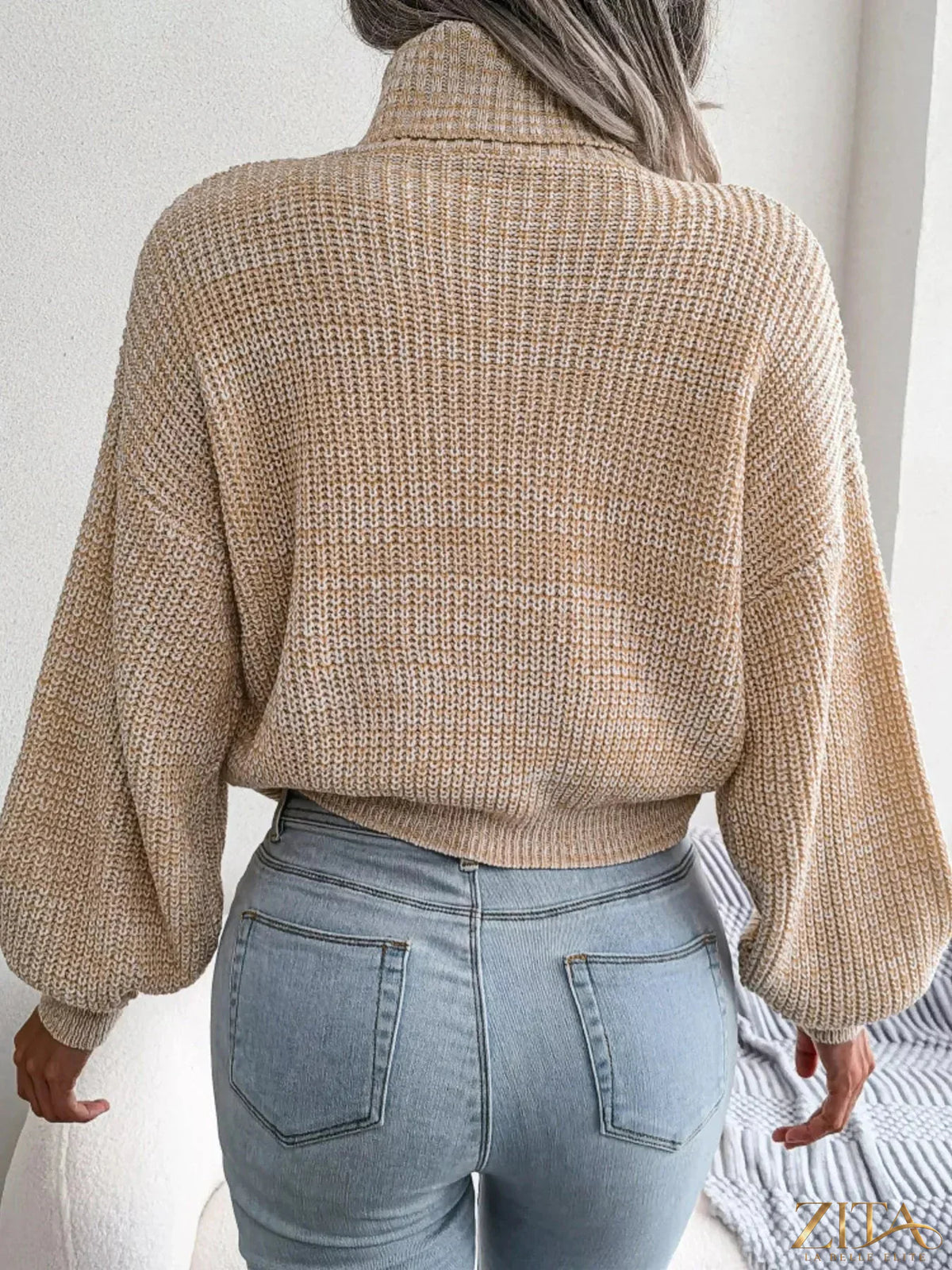 Soft beige turtleneck dropped shoulder sweater from Trendsi, featuring a cozy knit texture and relaxed fit.