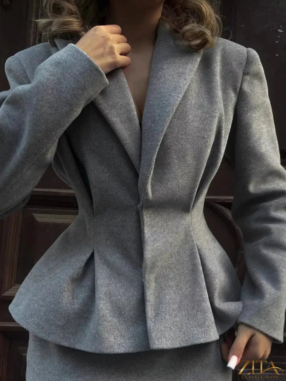 Peplum blazer and matching skirt set by Trendsi, stylish tailored design, in a neutral color, displayed on a mannequin.