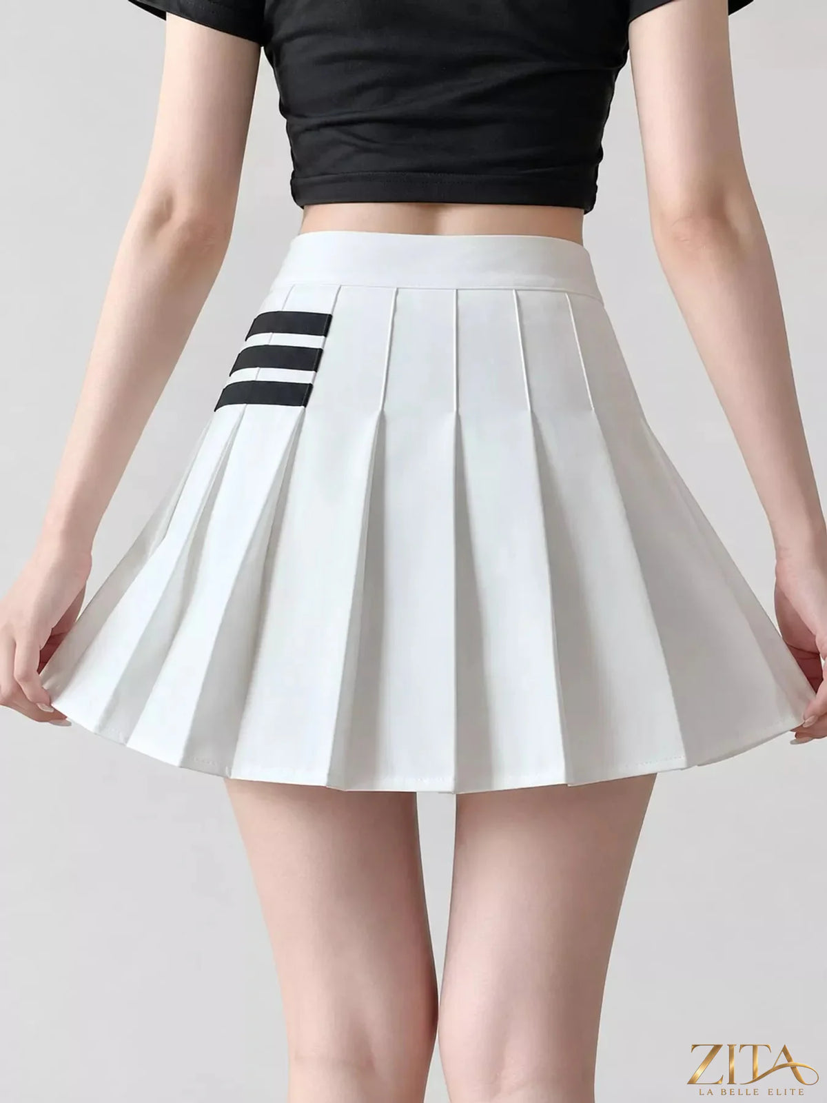 Contrast stripe pleated mini skirt by Trendsi, featuring a stylish pleated design with bold stripe patterns.