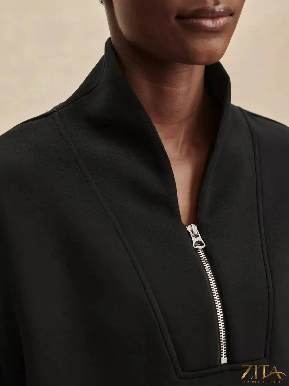 Zita La Belle Elite quarter-zip sweatshirt and wide-leg pants set in neutral fabric, displayed on a hanger.