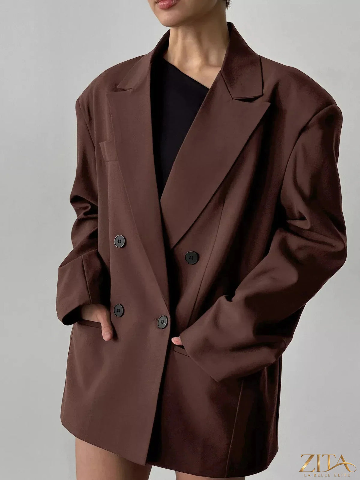 Double-breasted blazer with lapel collar in black, featuring structured fit and stylish design from Trendsi.