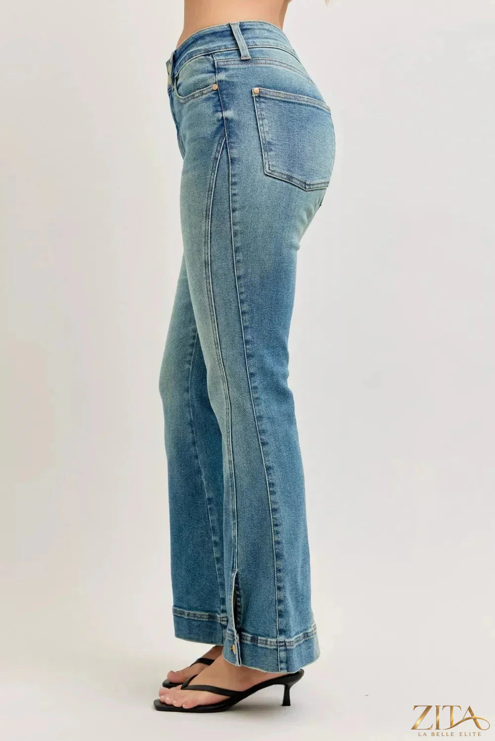 Zita La Belle Elite Judy Blue high waist vintage wash flare jeans hanging on a rack with distressed details and classic five-pocket style.
