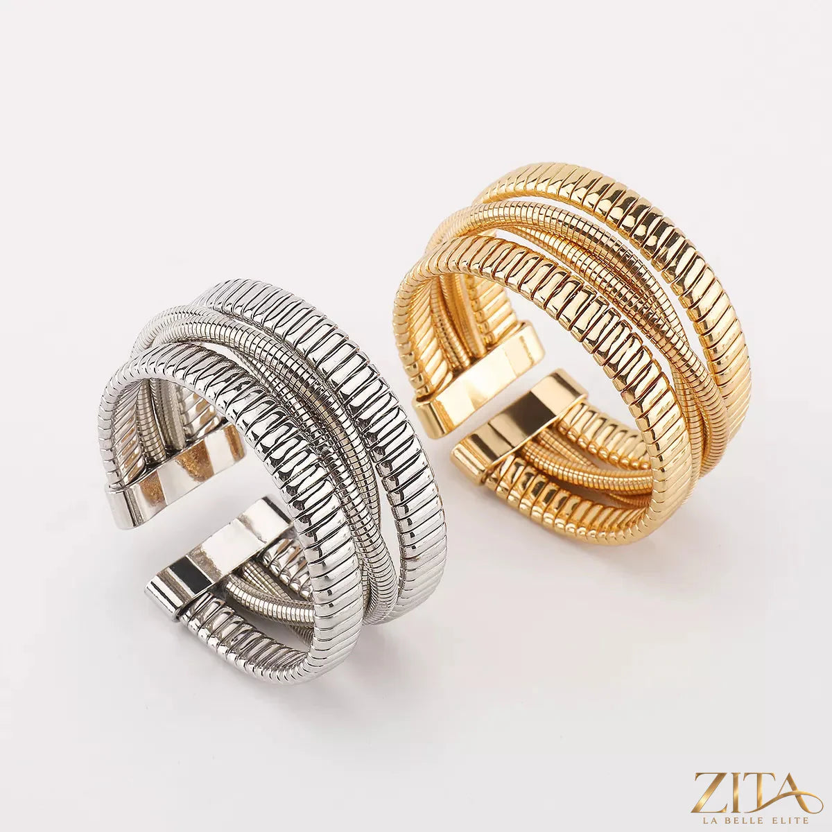 Multi-layered open bracelet by Zita La Belle Elite featuring delicate gold and silver chains with small charms and open cuff design.