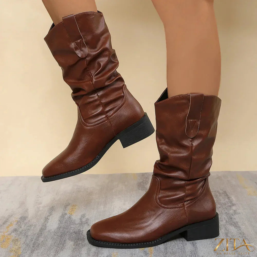 Trendsi pleated pull-on western cowboy boots with pointed toes and stacked heels, featuring classic western stitching and leather finish.