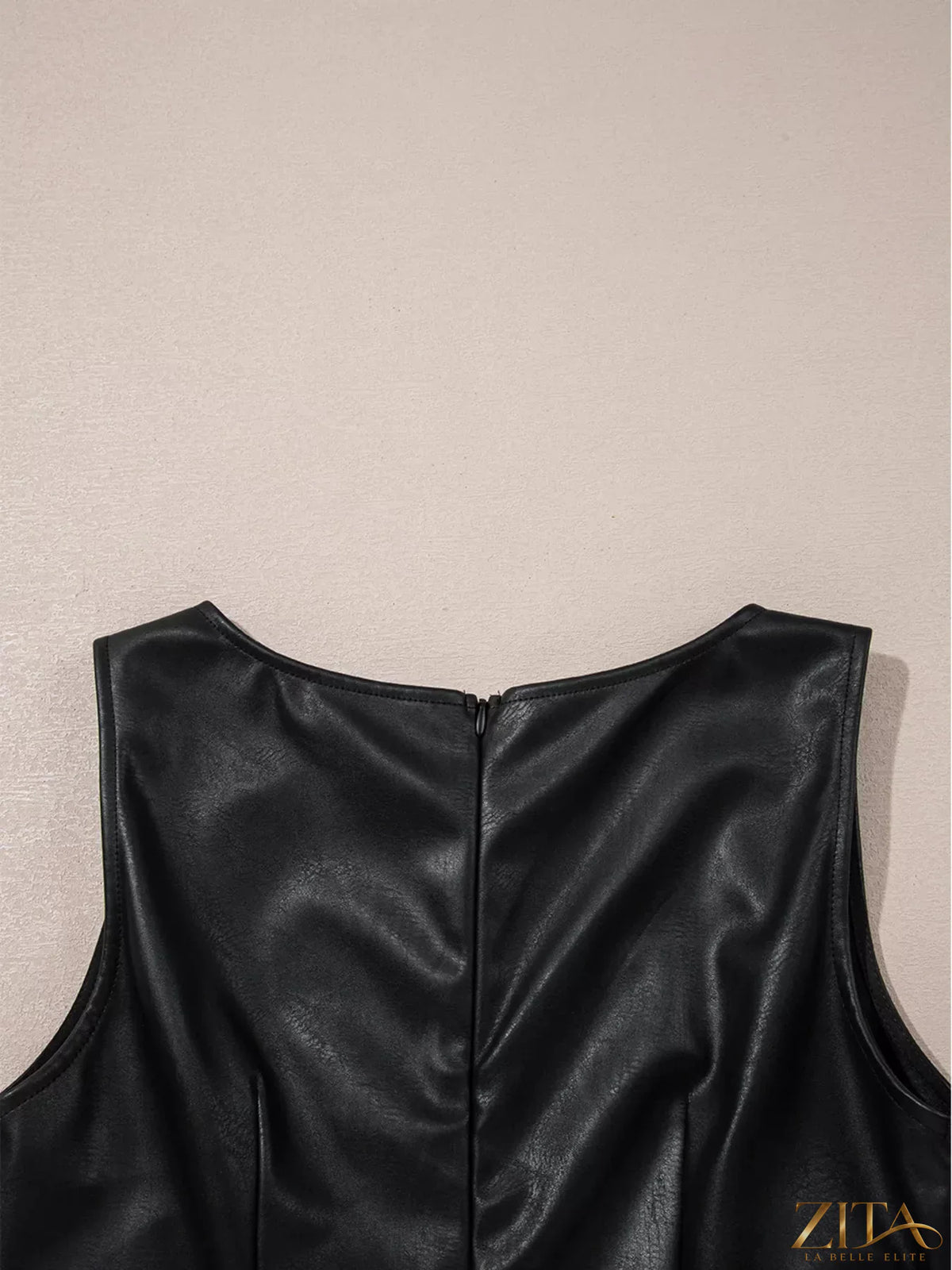 Zita La Belle Elite vegan leather sleeveless mini dress with fitted silhouette and stylish design, shown on a model.