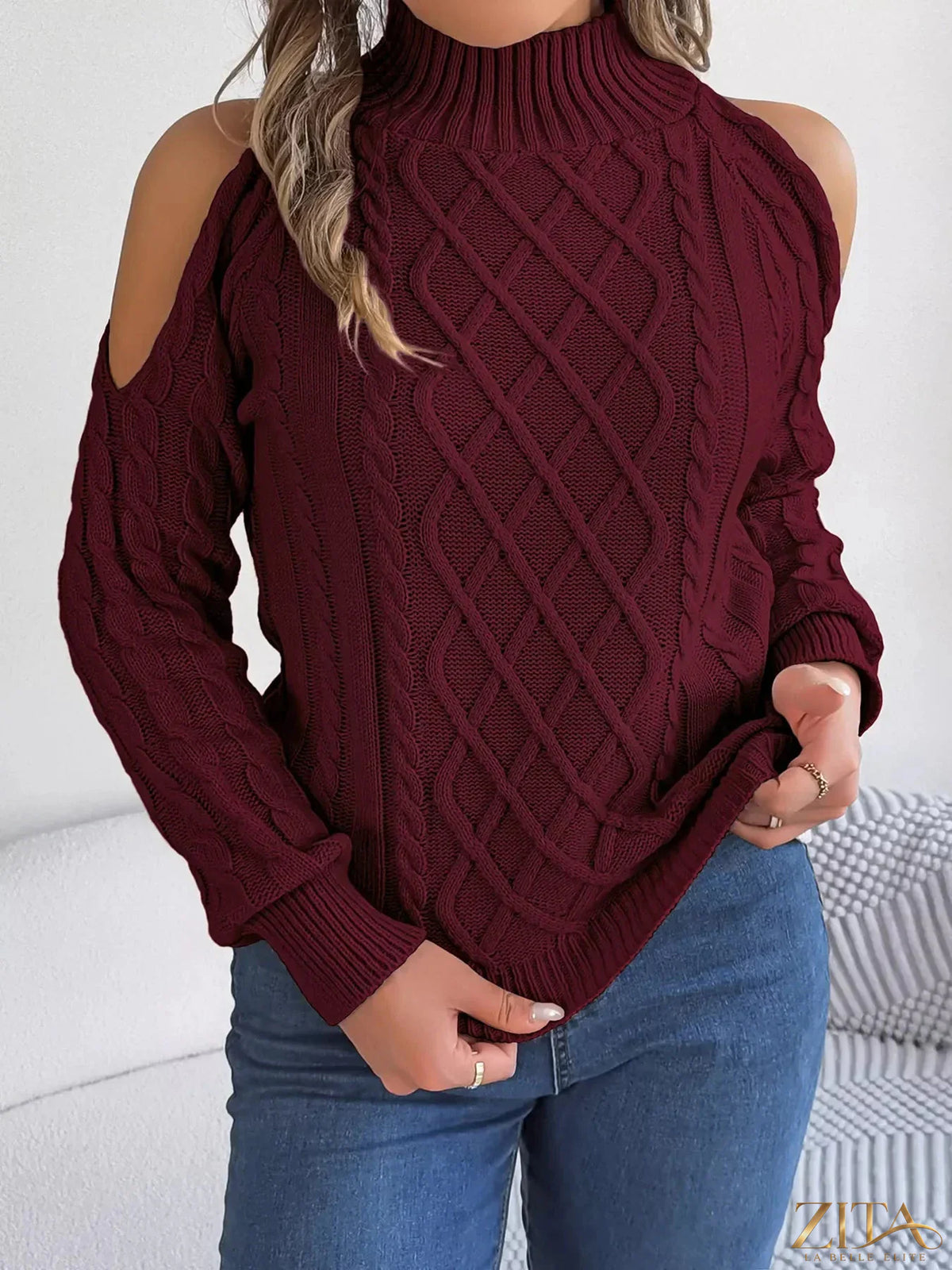 Zita La Belle Elite cold-shoulder cable knit sweater featuring a cozy design with open shoulders and textured knit pattern.