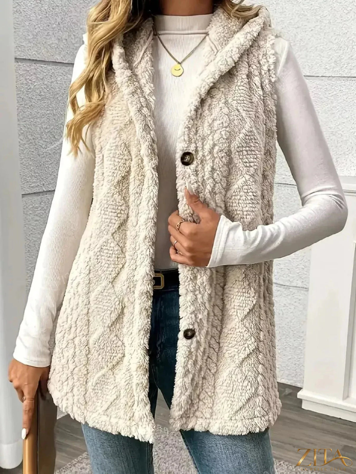 Zita La Belle Elite hooded button-up sherpa vest coat showing beige sherpa fabric, front buttons, and hood detail.