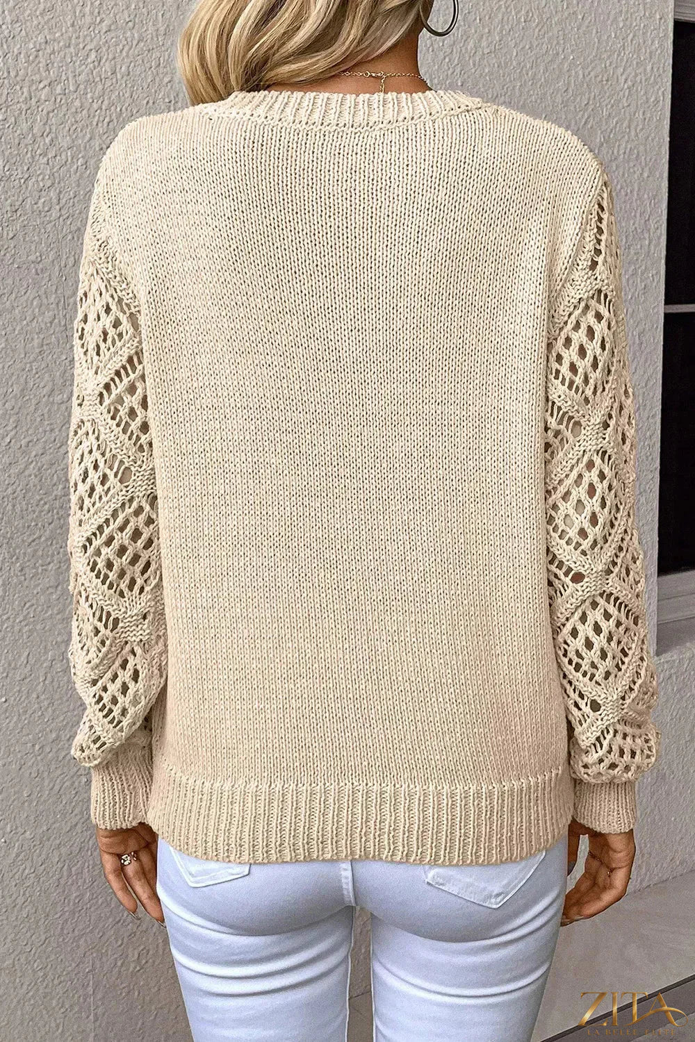 V-neck crochet sleeve sweater by Trendsi, featuring a stylish V-neck design and textured crochet sleeves in a cozy knit fabric.