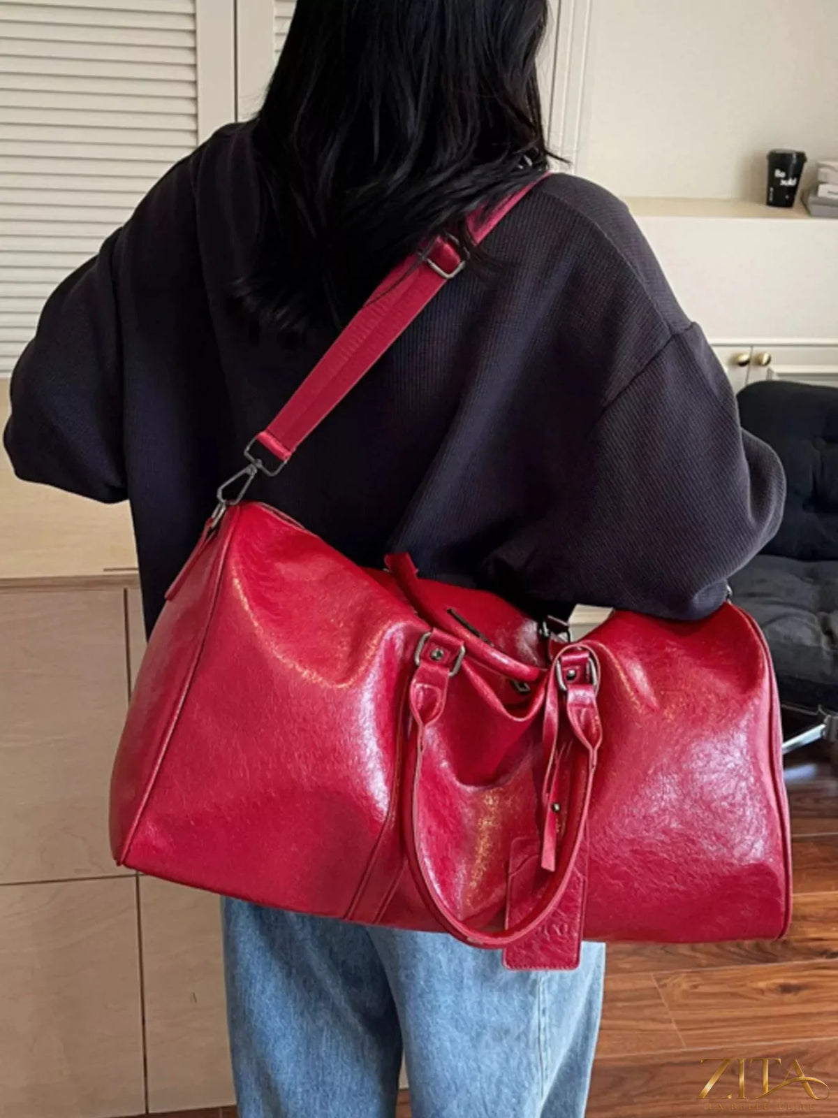 Trendsi PU leather duffle bag with sturdy handles and spacious main compartment for travel or gym use.