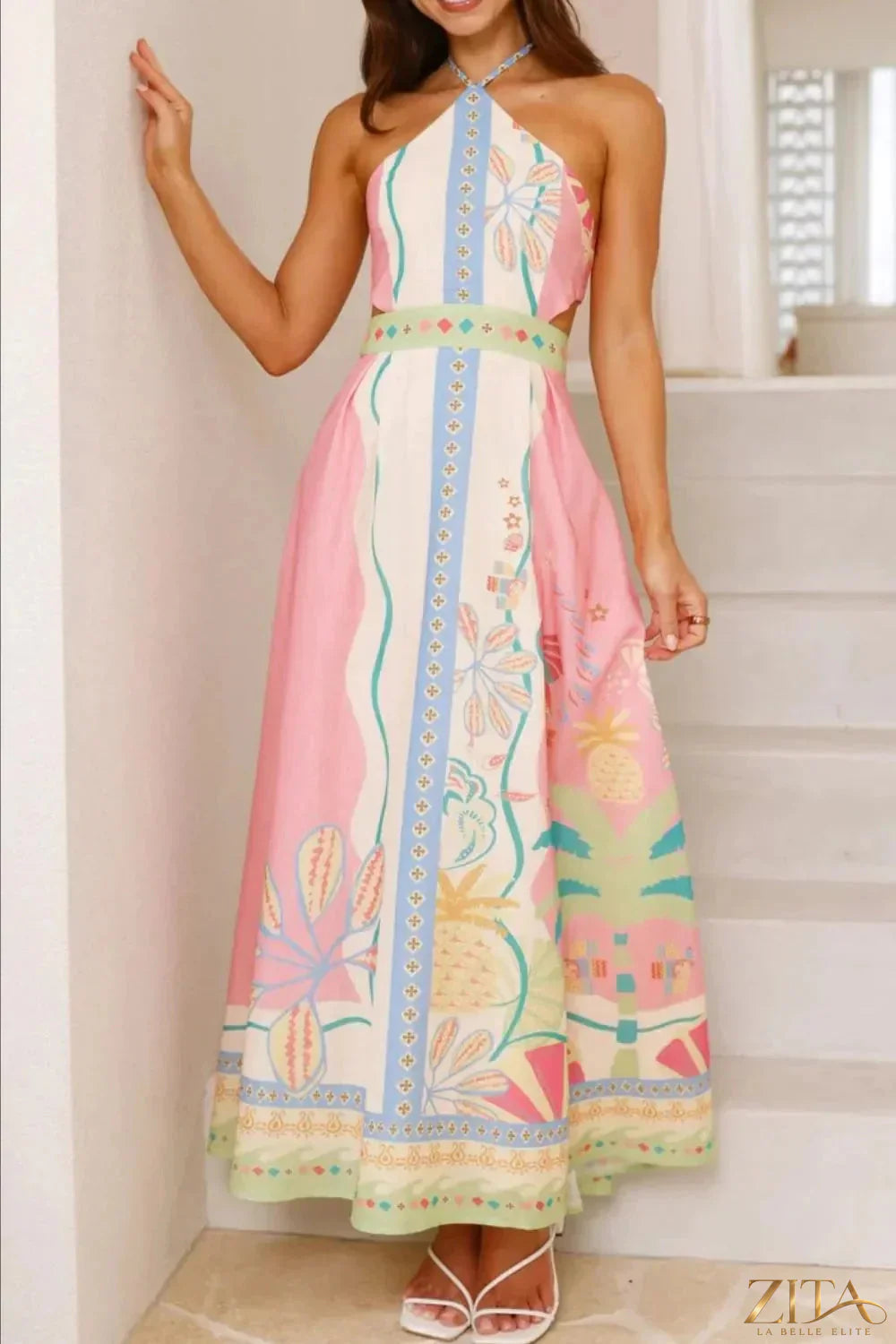 Printed halter neck maxi dress by Zita La Belle Elite featuring a flowing design and vibrant floral pattern.
