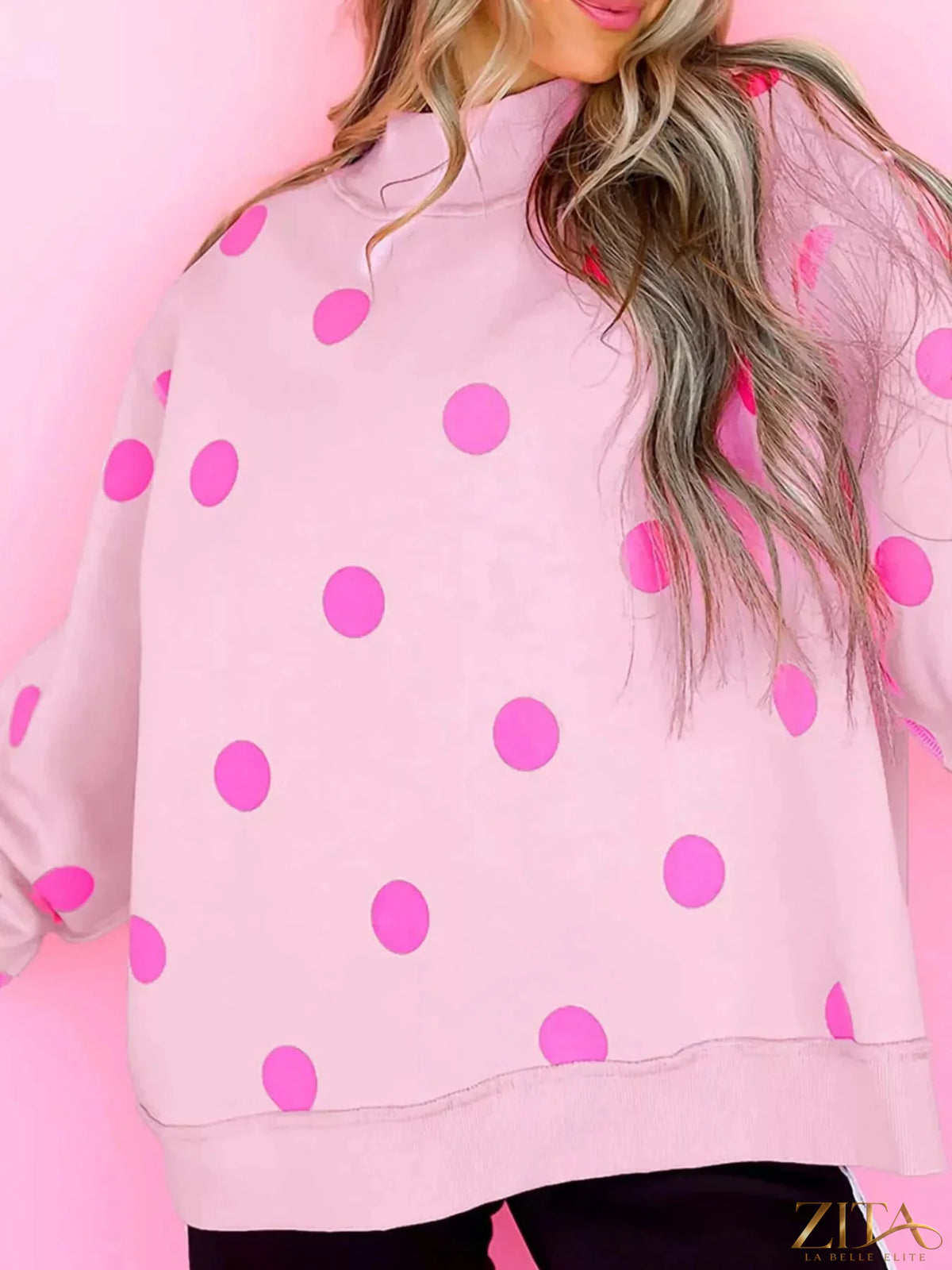 Zita La Belle Elite polka dot mock neck oversized sweatshirt in white with black dots, featuring a cozy, relaxed fit.